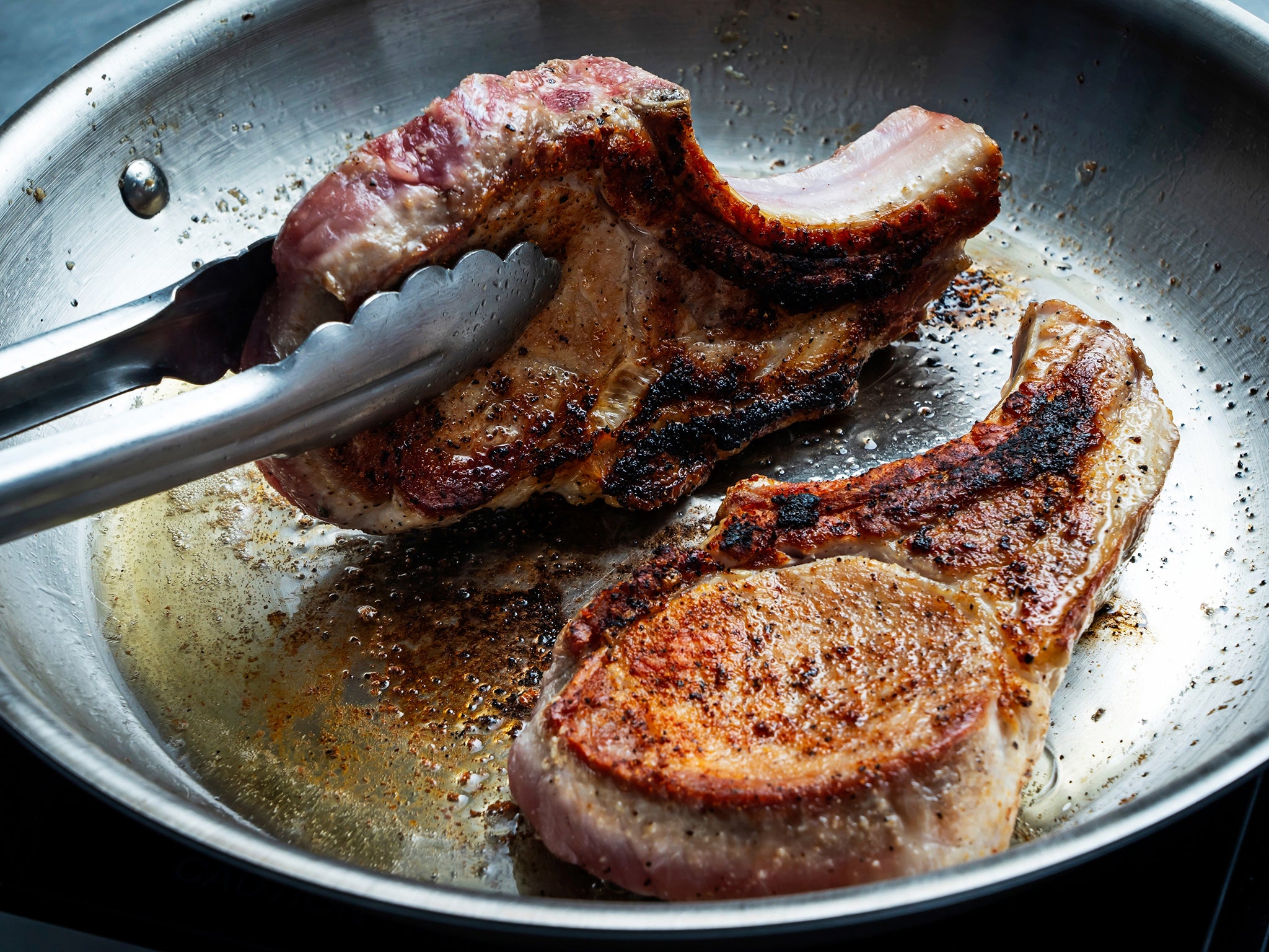 Use tongs to stand the chops on their side in the pan, fat side down, to render some of the fat