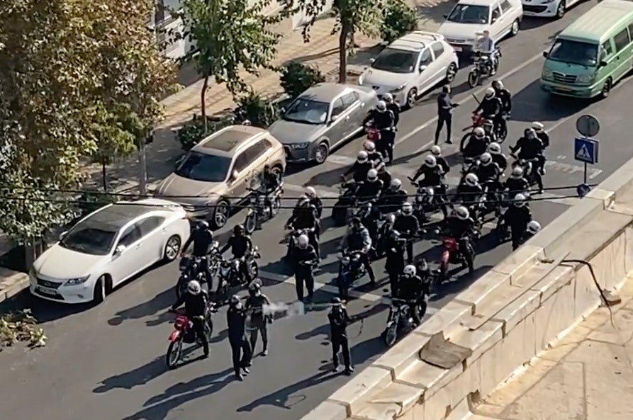 Iranian police arrive to disperse a protest in Tehran