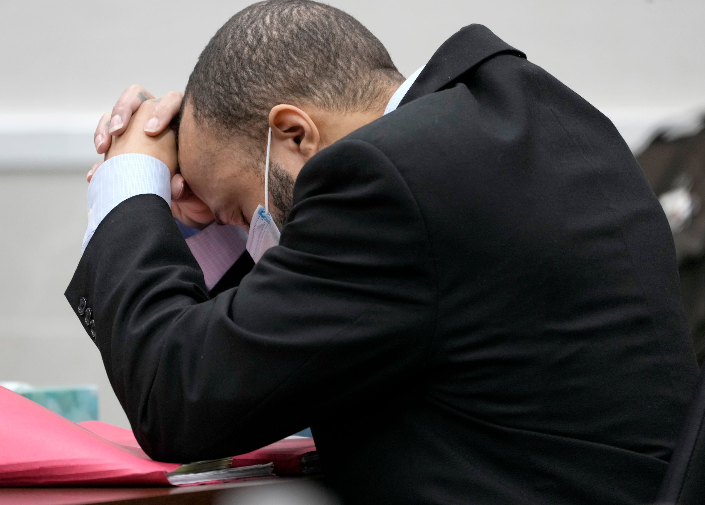 Darrell Brooks puts his head in his hands as the verdict is read out