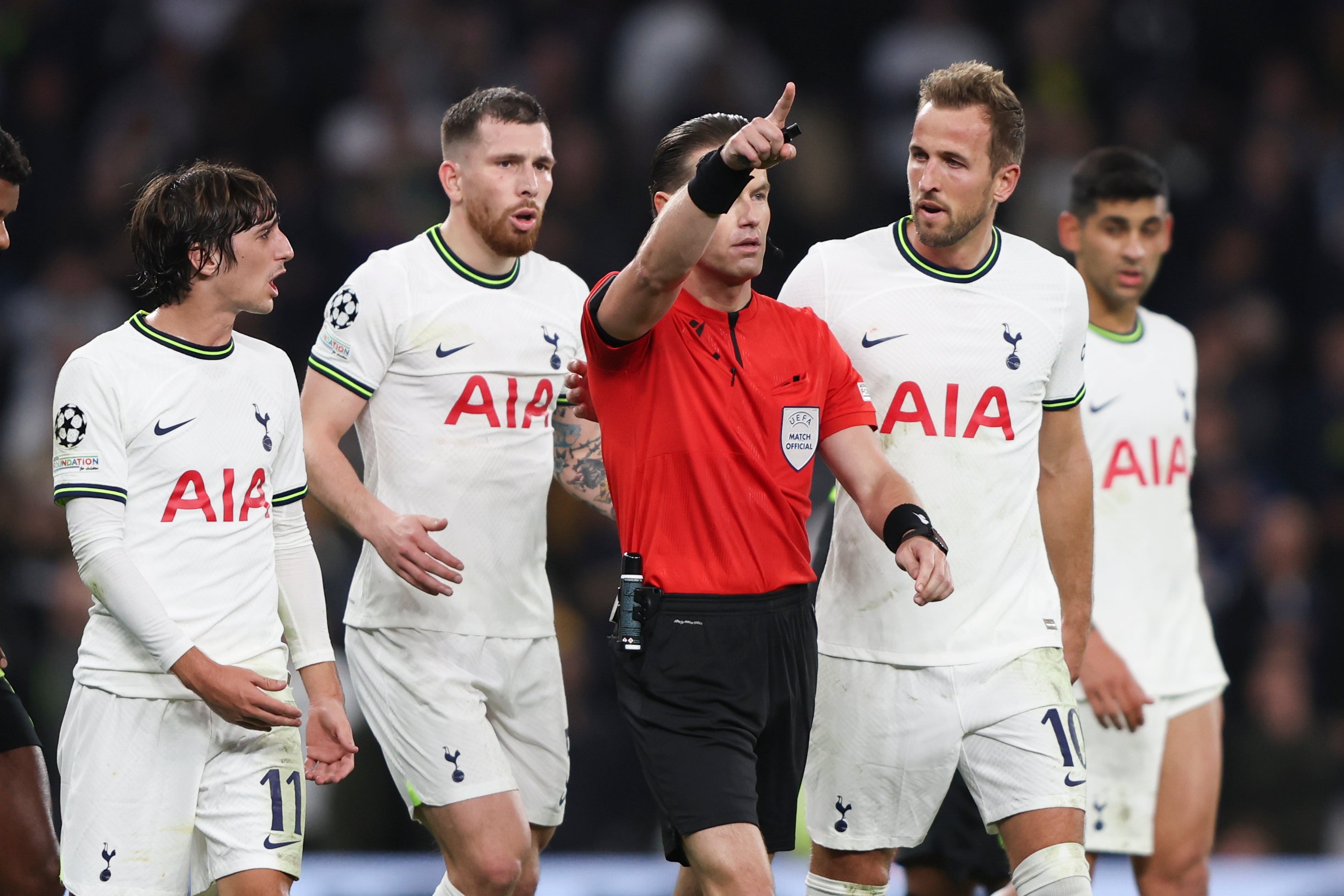 Referee Danny Makkelie gestures as Tottenham players react