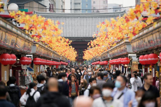 <p>Tourists walk through a promenade lined with souvenir shops leading to the Sensoji Buddhism temple in the famed Asakusa district of Tokyo</p>