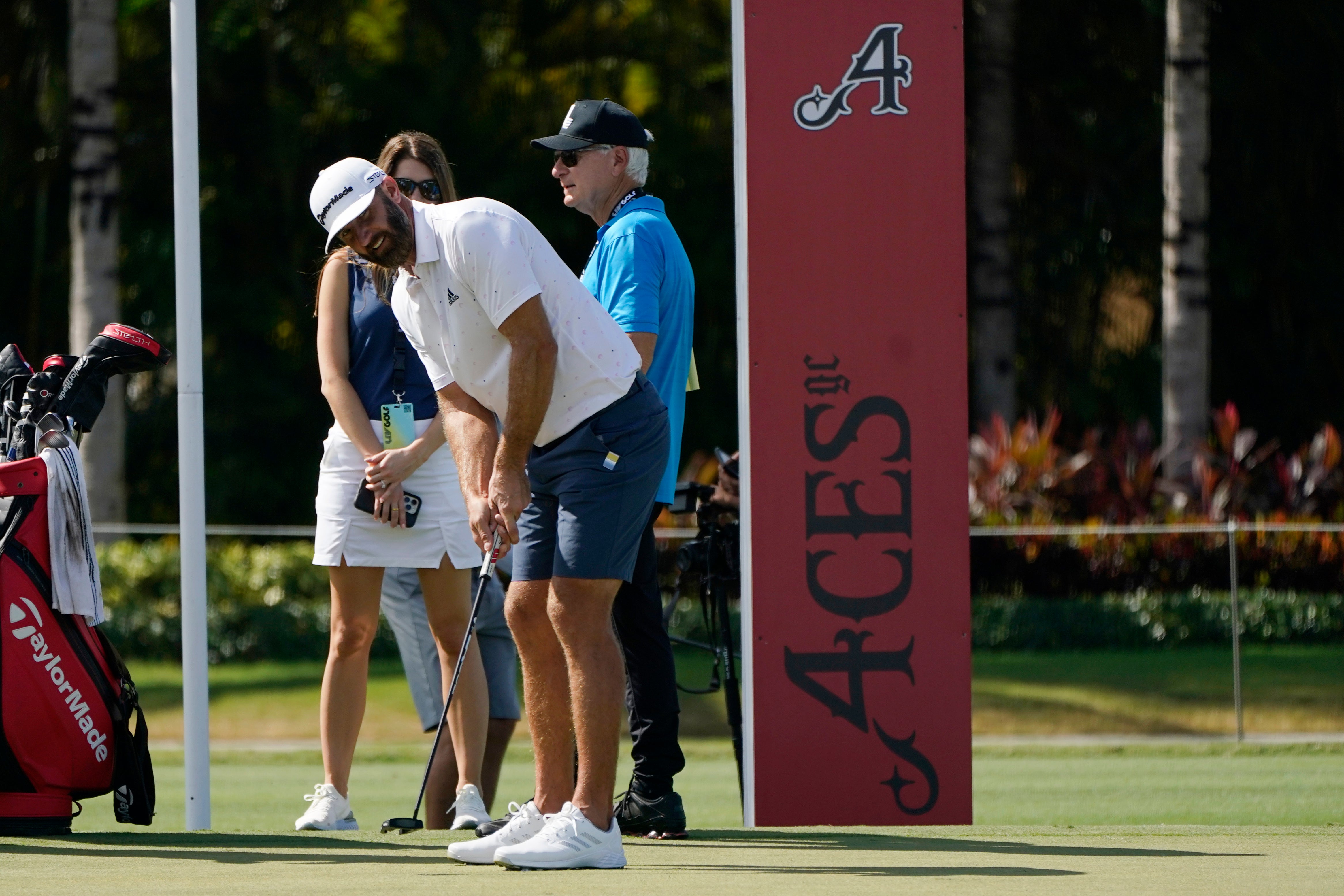 Dustin Johnson hits on the putting green before the LIV Golf Team Championship at Trump National Doral Golf Club