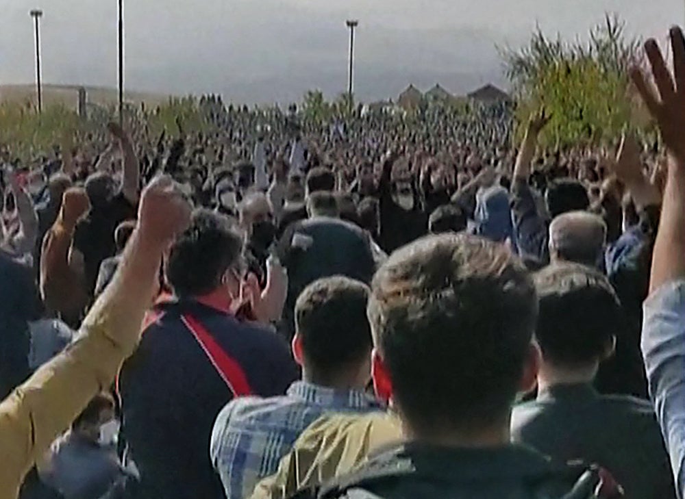 Hundreds of protesters clapping and cheering during a rally in Saqez, Mahsa Amini’s hometown