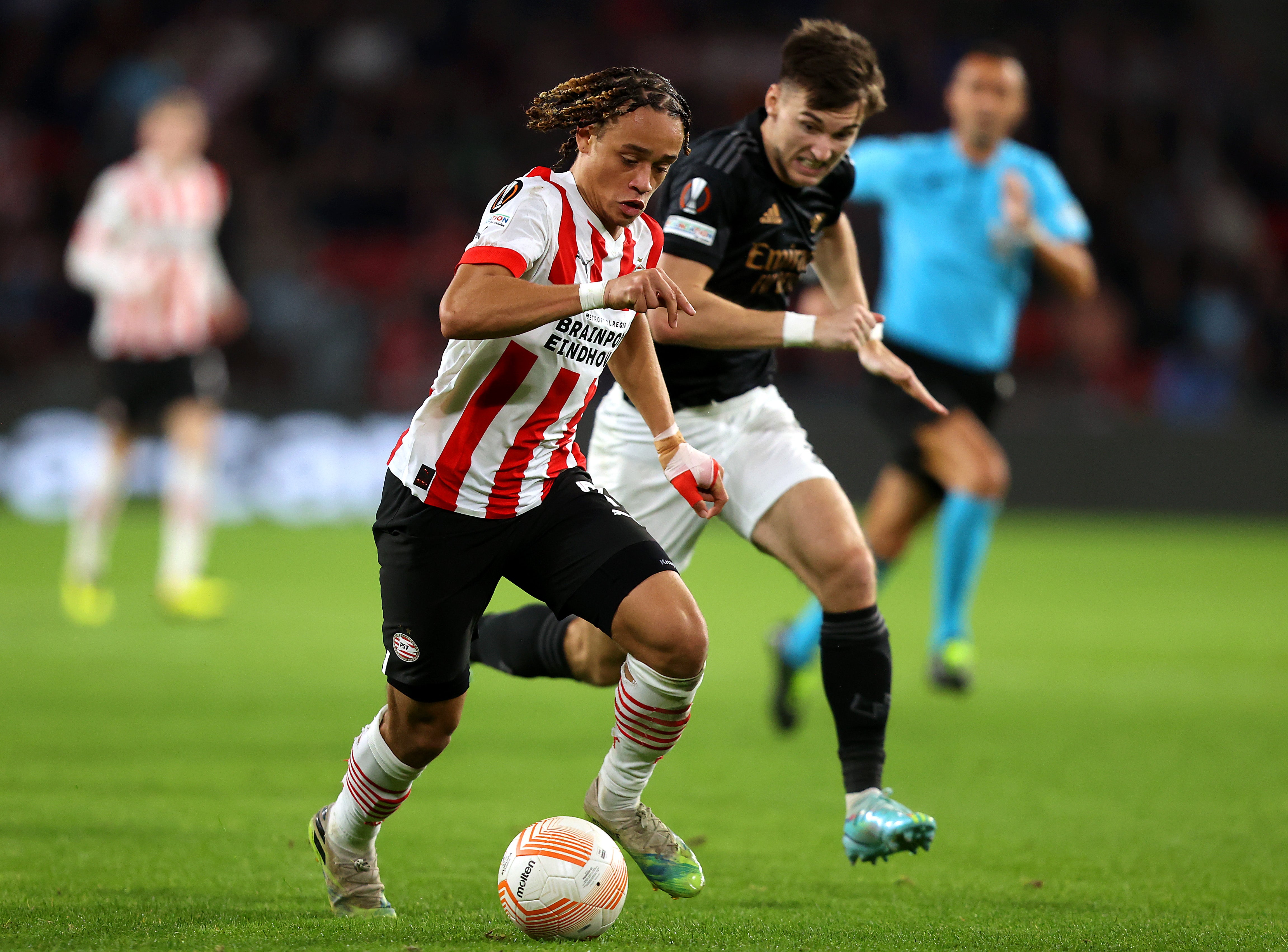 Xavi Simons of PSV Eindhoven is challenged by Kieran Tierney of Arsenal