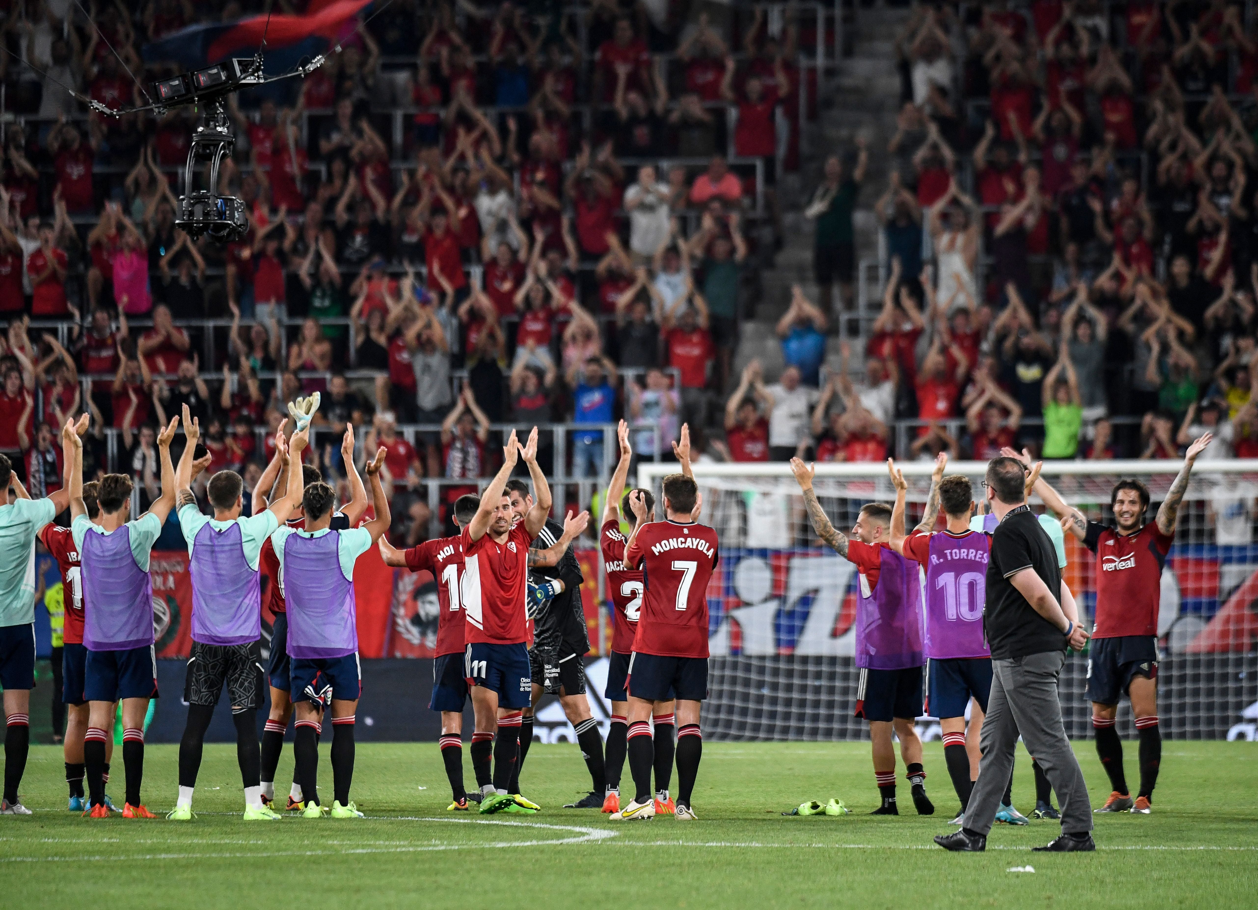 Osasuna’s players celebrate with their fans at El Sadar stadium in Pamplona