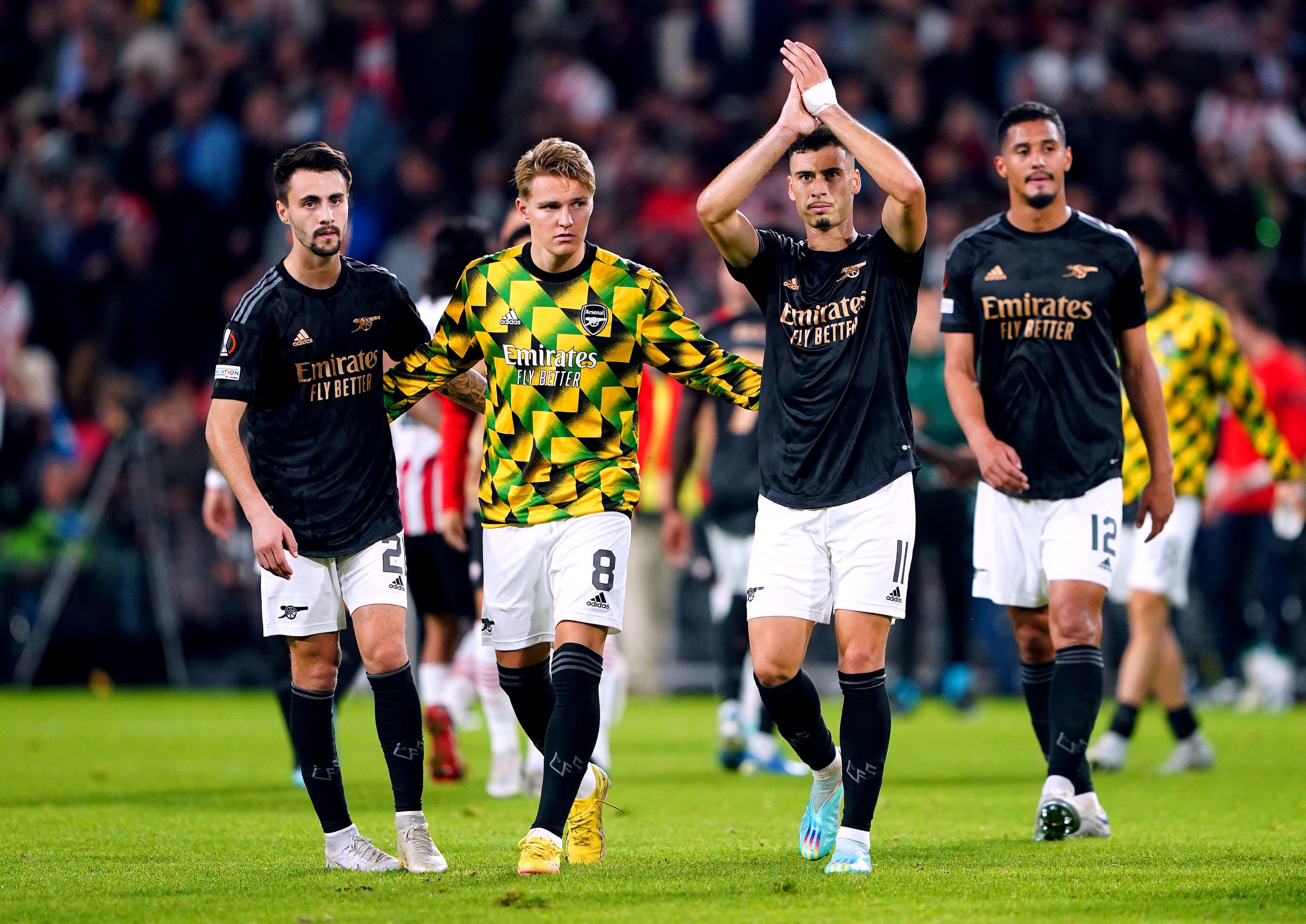 Arsenal players salute their fans after defeat at PSV