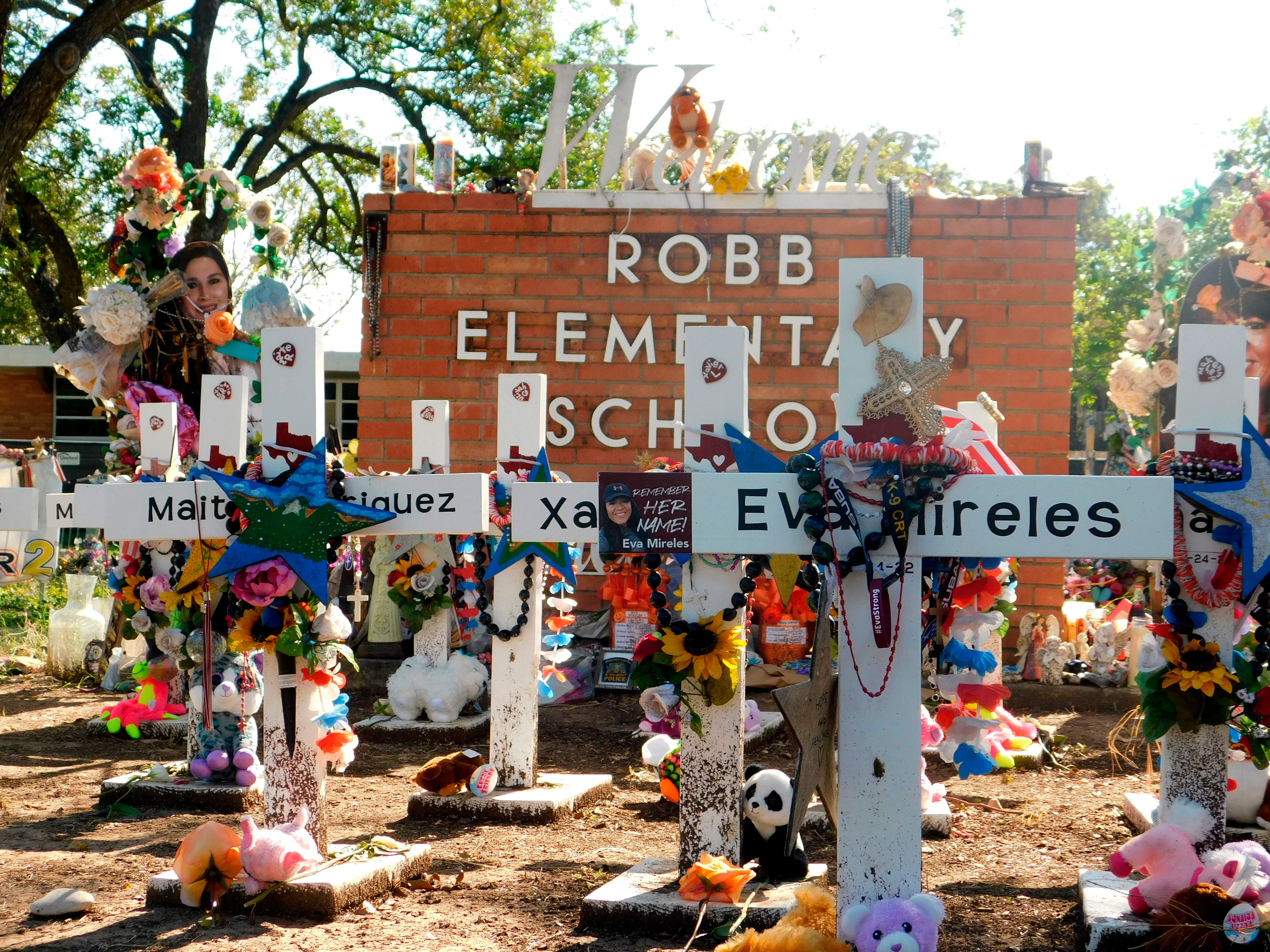 A memorial for the 19 children and two teachers killed in the May shooting sits outside the school