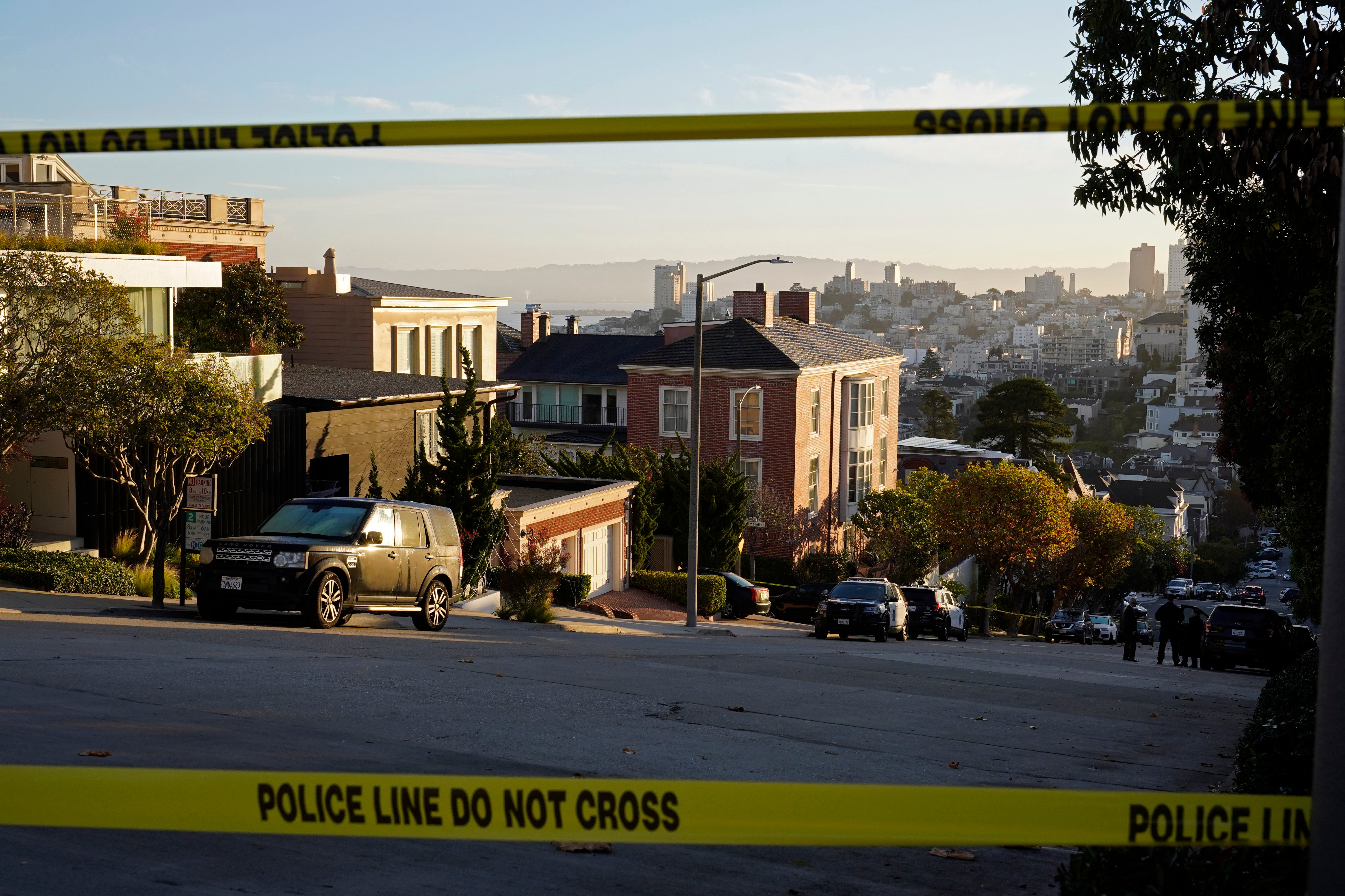 Police tape blocks a street outside the home of Paul and Nancy Pelosi