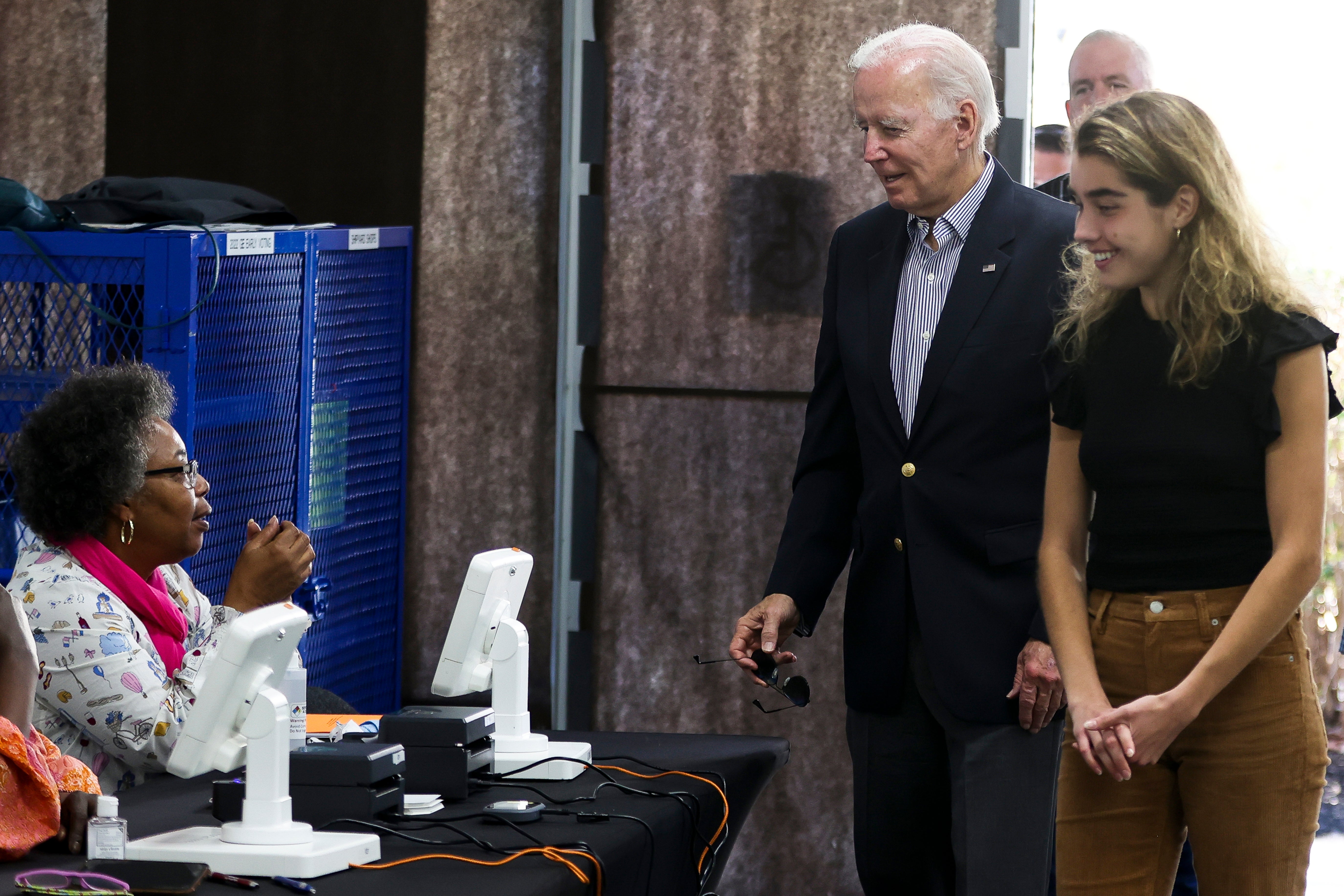 President Joe Biden arrives to cast his vote during early voting for the 2022 U.S. midterm elections with his granddaughter