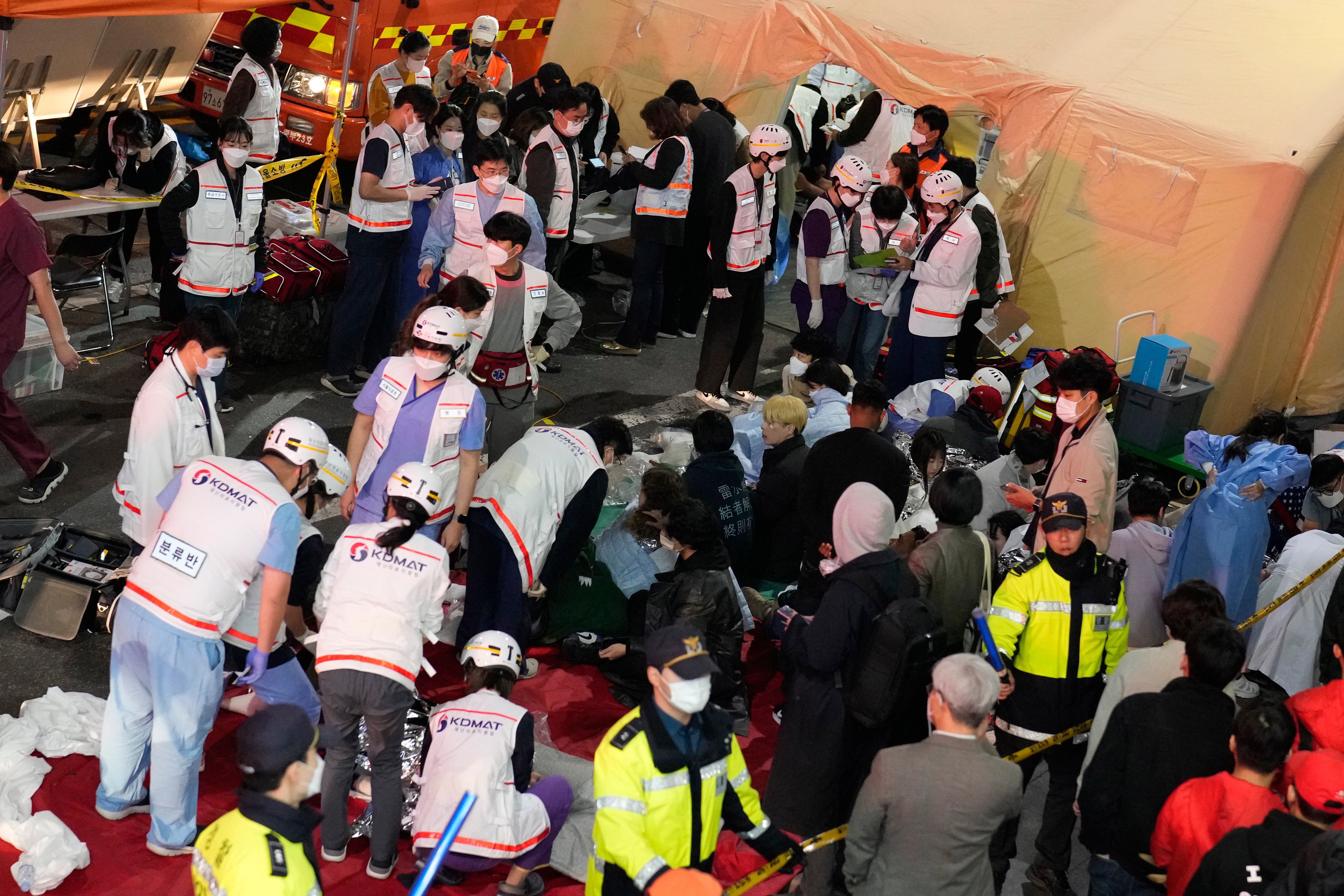 Rescue workers treat injured people on the street near the scene in Seoul