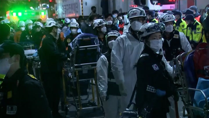 Seoul Halloween stampede: Emergency workers move bodies from site of deadly crush in South Korean capital
