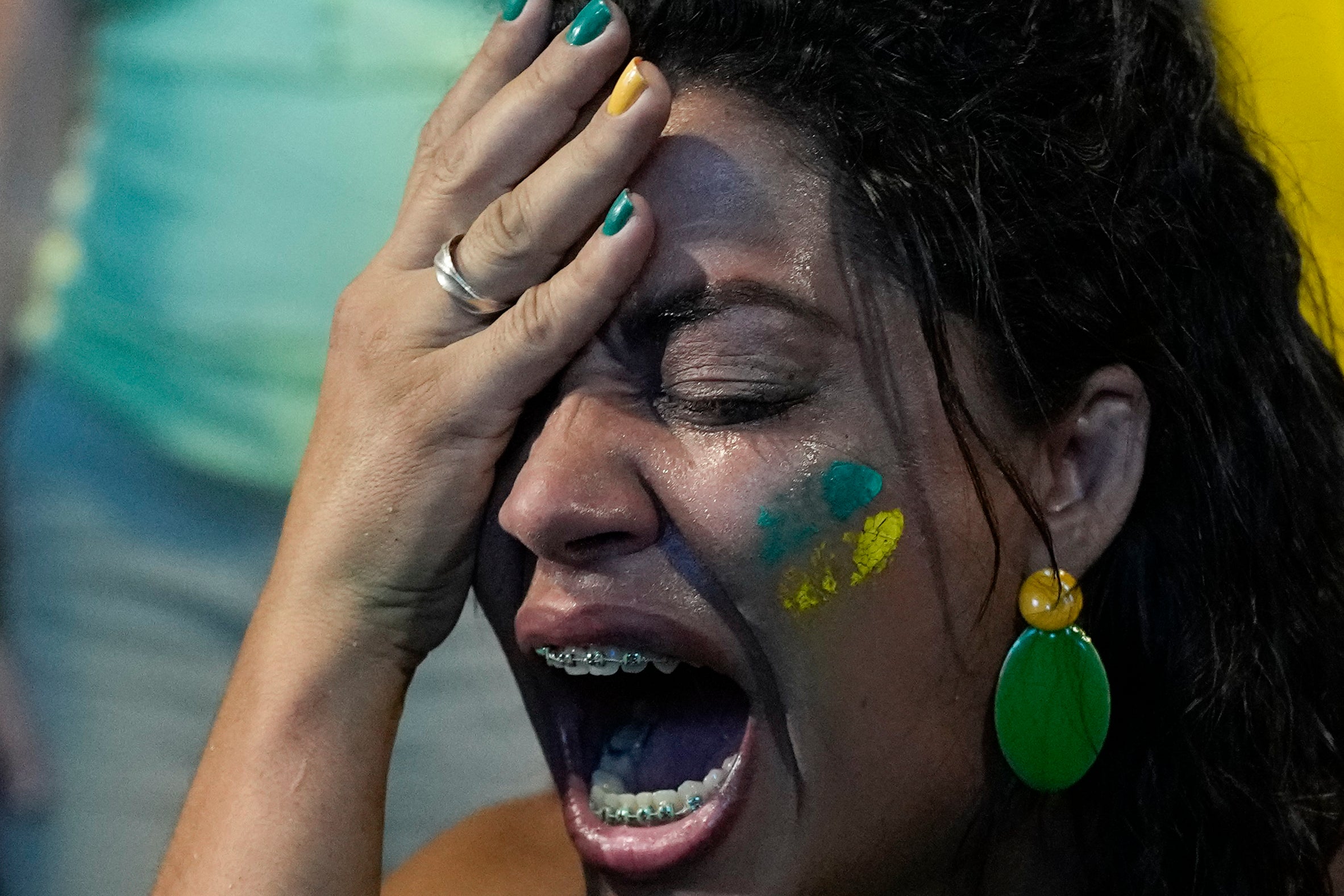 A supporter of Brazilian President Jair Bolsonaro reacts to results after polls closed in a presidential run-off election