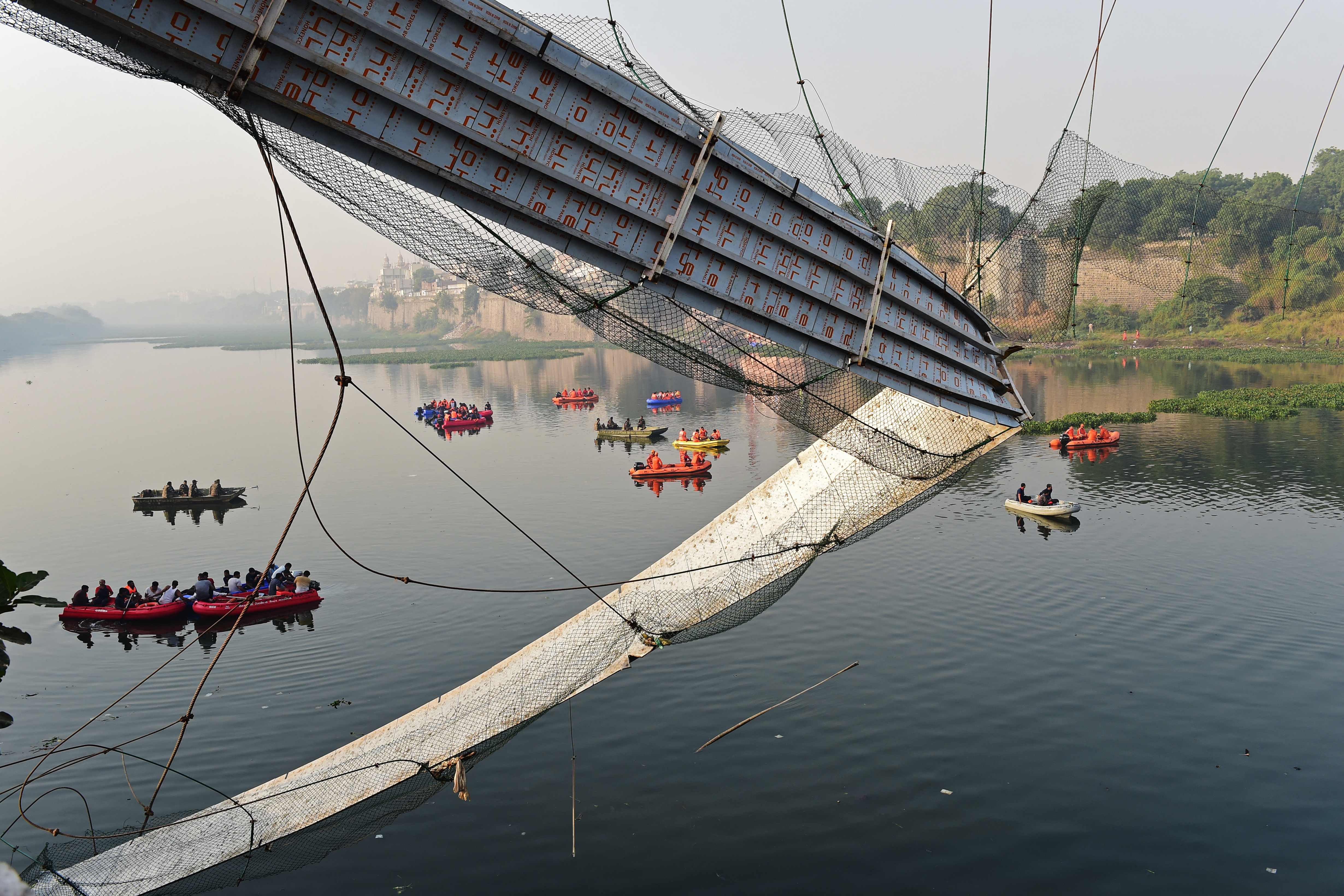 Rescue personnel conduct search operations after a bridge across the river Machchhu collapsed at Morbi in India's Gujarat