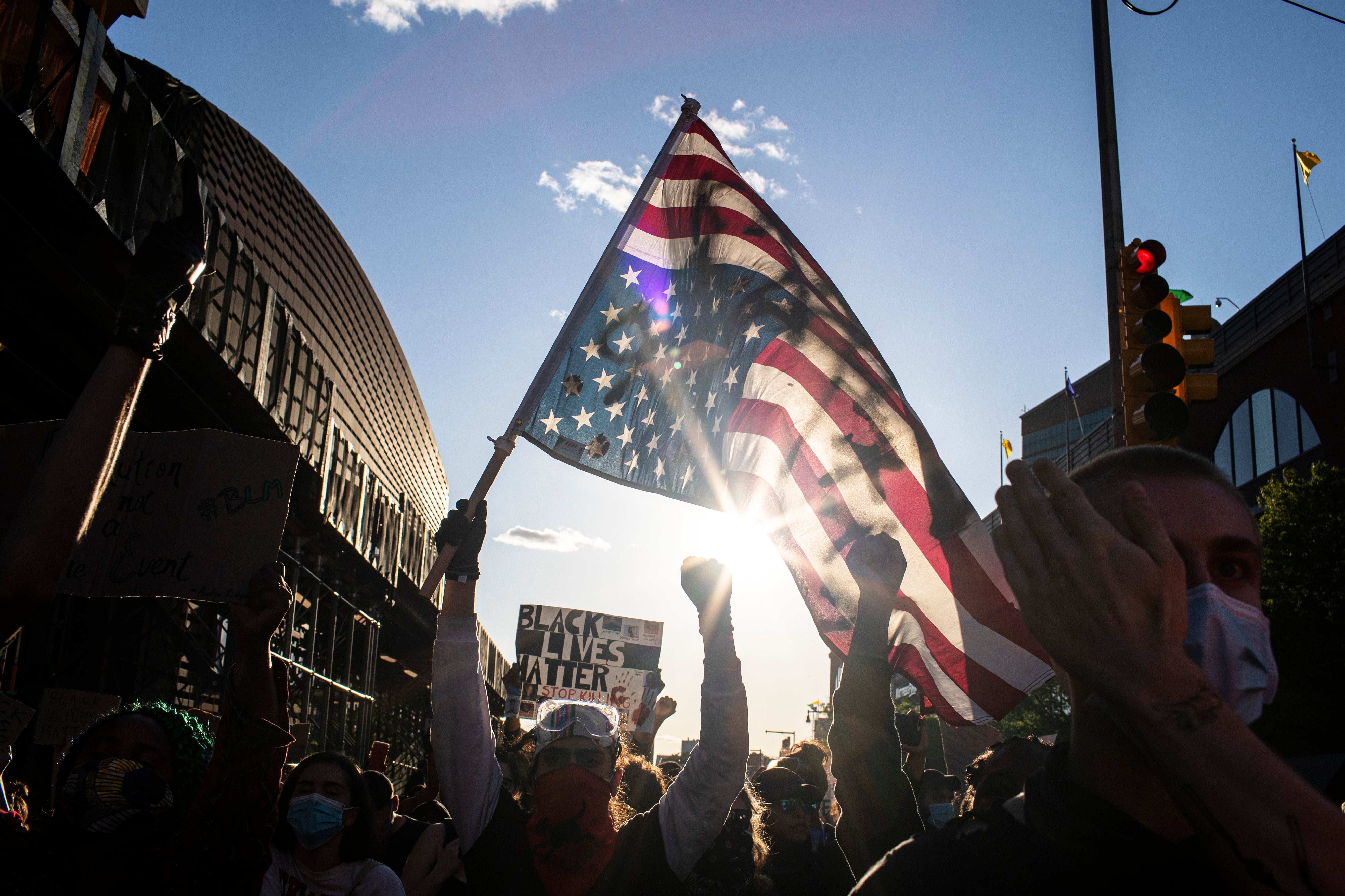 Maga supporters parade the upside-down flag