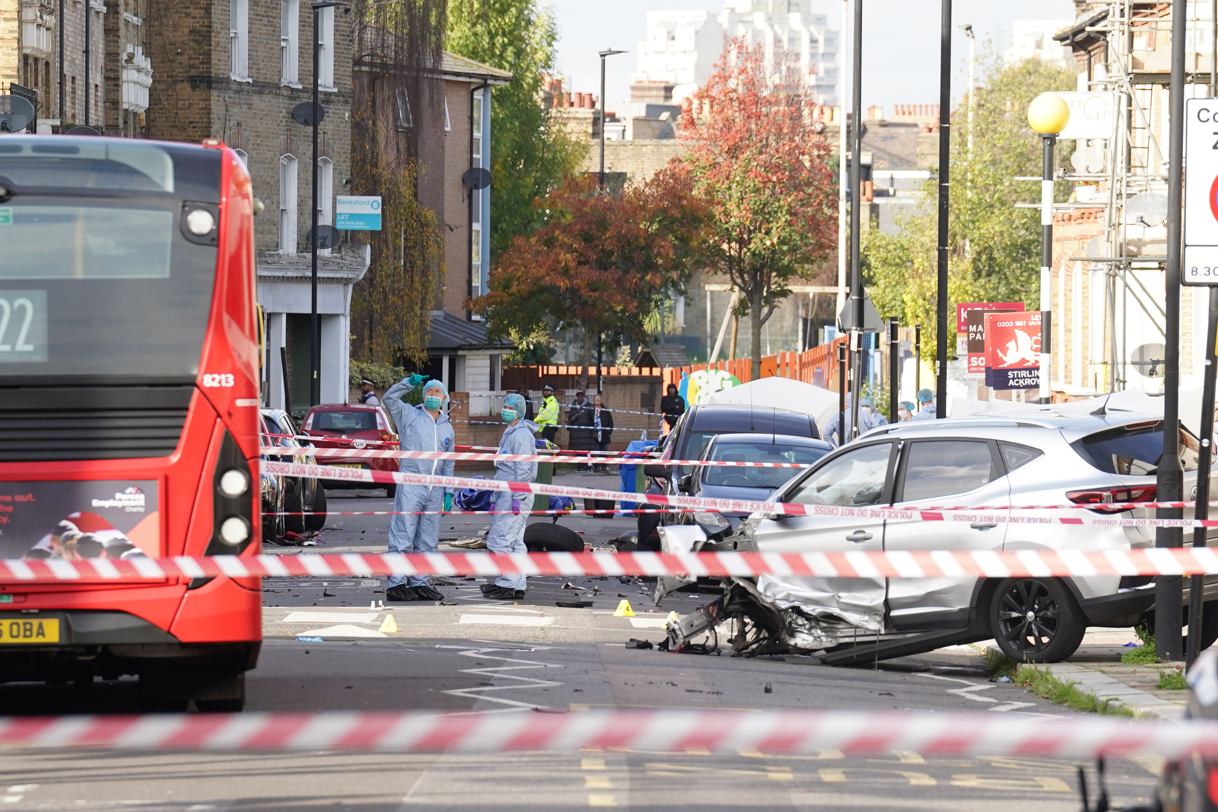 Police officers in forensic suits at the scene in south London (Stefan Rousseau/PA)