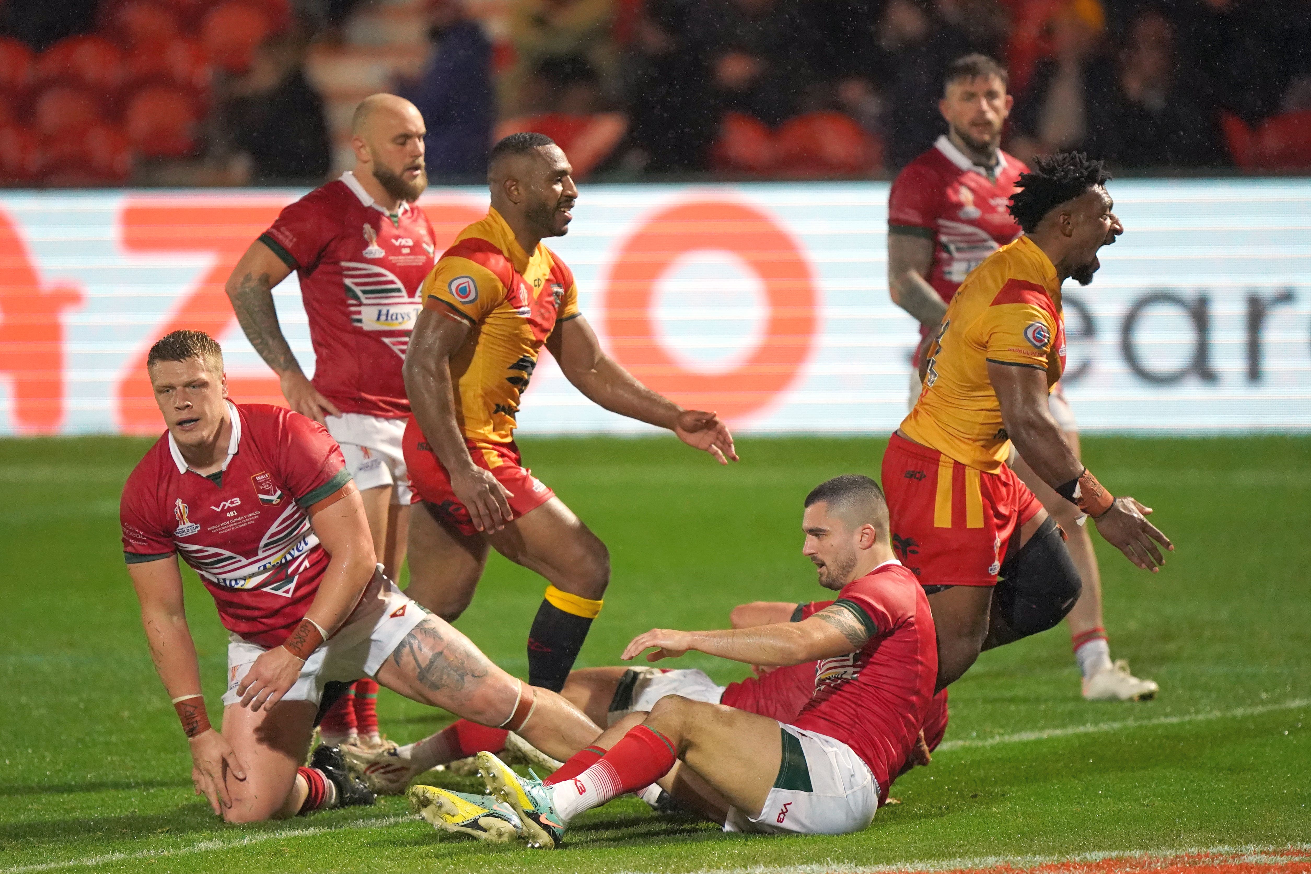 Papua New Guinea’s Nixon Putt, right, celebrates a try (Tim Goode/PA)