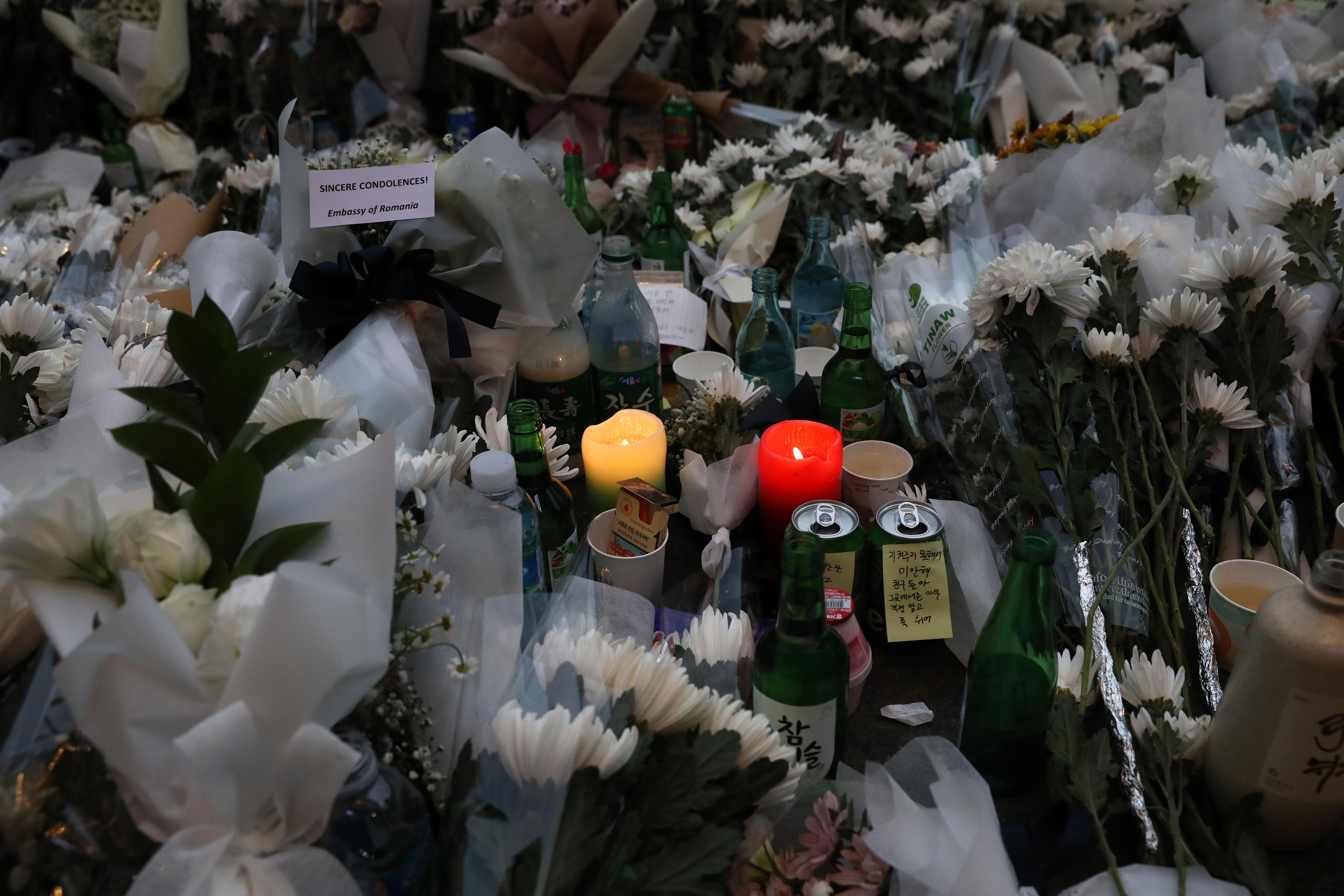 A woman pays tribute for the victims of the Halloween celebration stampede, on the street near the scene on 31 October 2022 in Seoul, South Korea