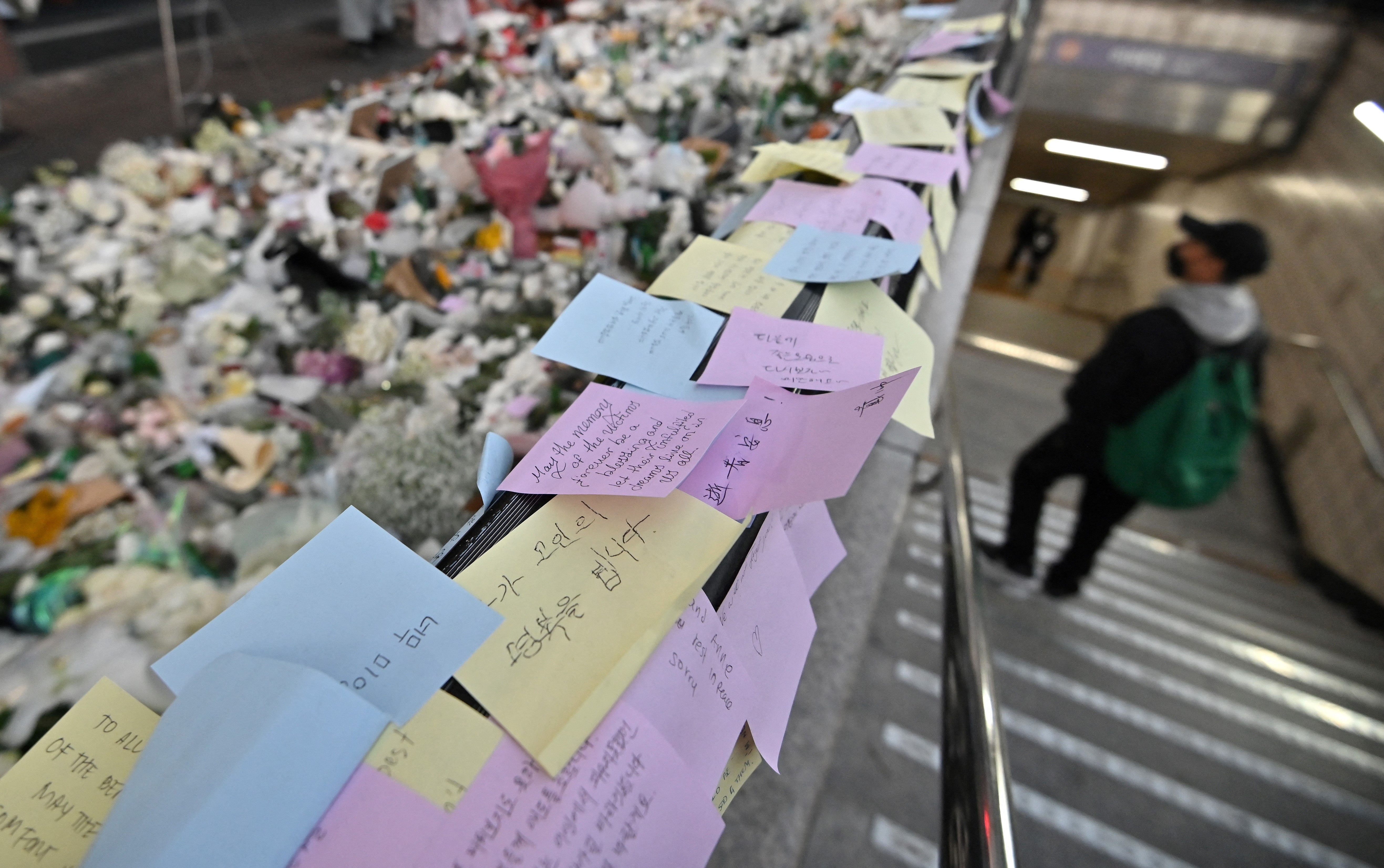 Messages from mourners are pictured at a makeshift memorial for the victims of the deadly Halloween crowd surge, outside a subway station in the district of Itaewon in Seoul on 1 November 2022