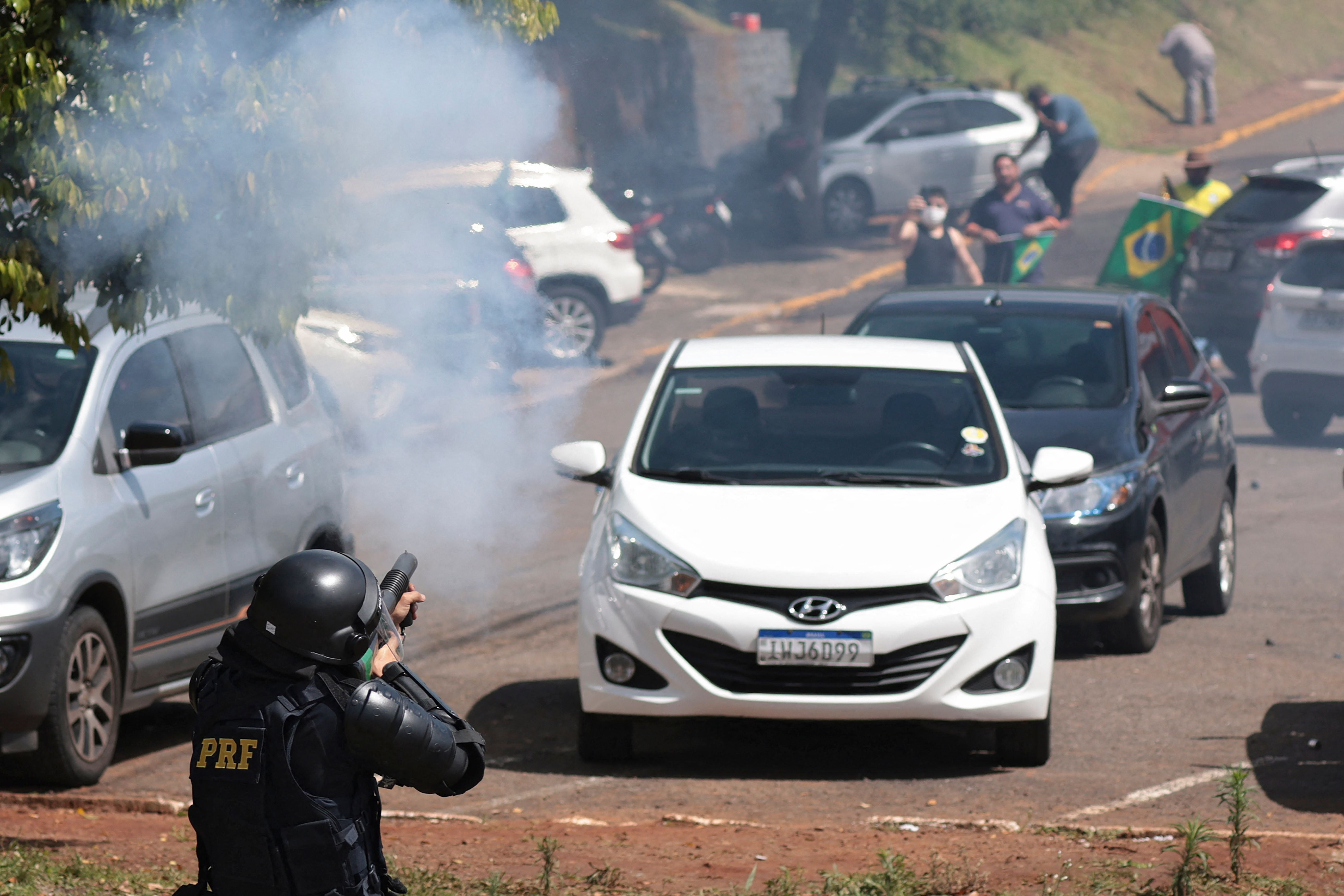 Military police fire at a roadblock by Bolsonaro supporters on the BR-116 highway in Rio Grande do Sul State, Brazil