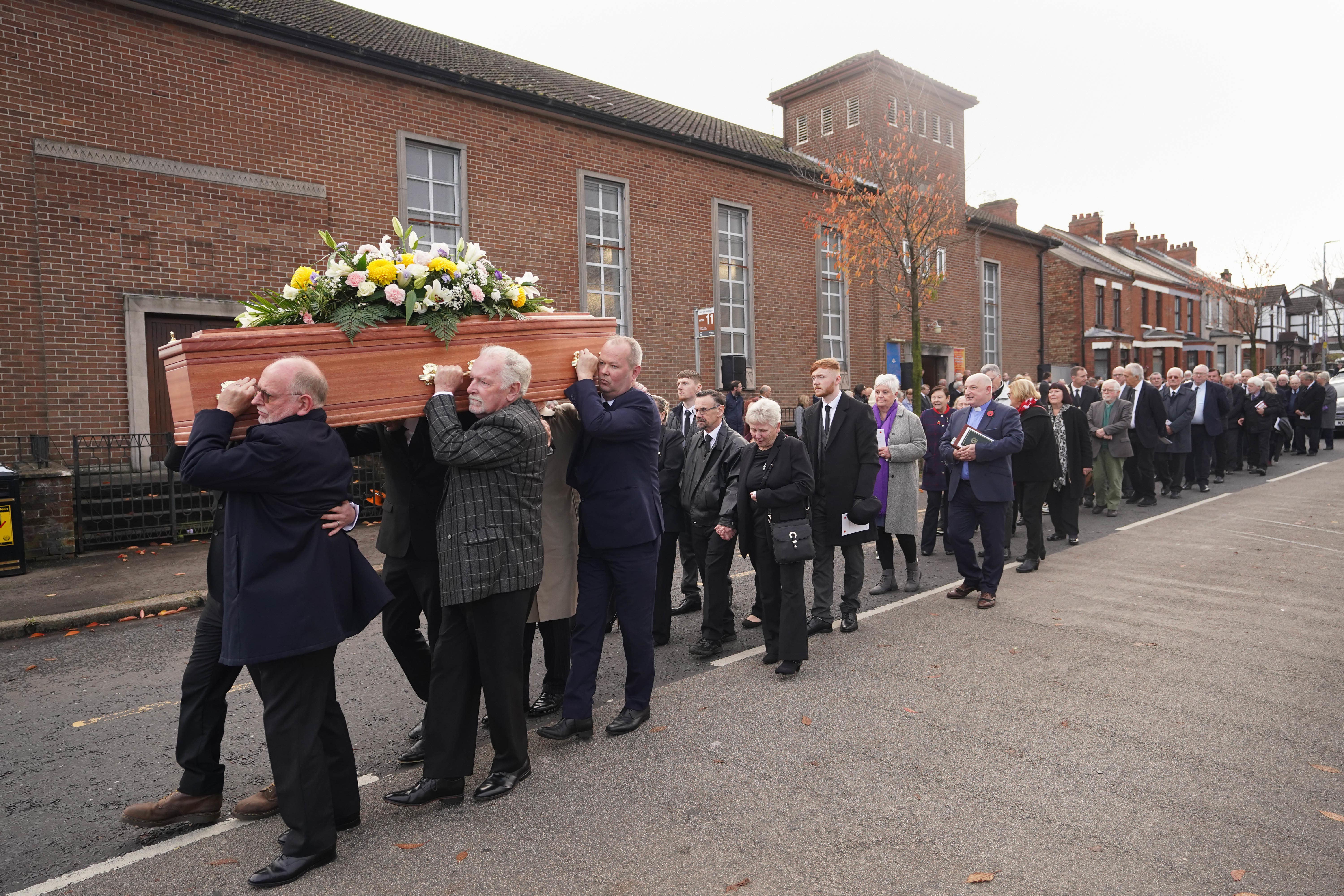 The coffin of Baroness May Blood is carried from Ballygomartin Presbyterian Church in Belfast after her funeral (Niall Carson/PA)