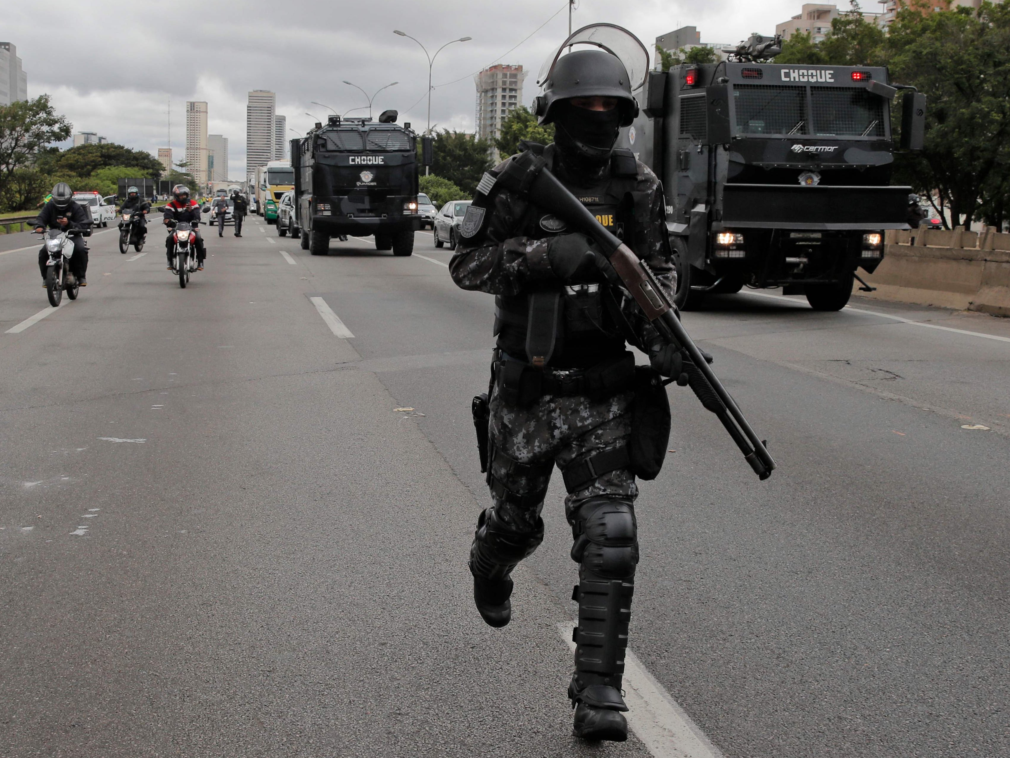 Military police try to clear a roadblock by supporters of Bolsonaro on the outskirts of Sao Paulo