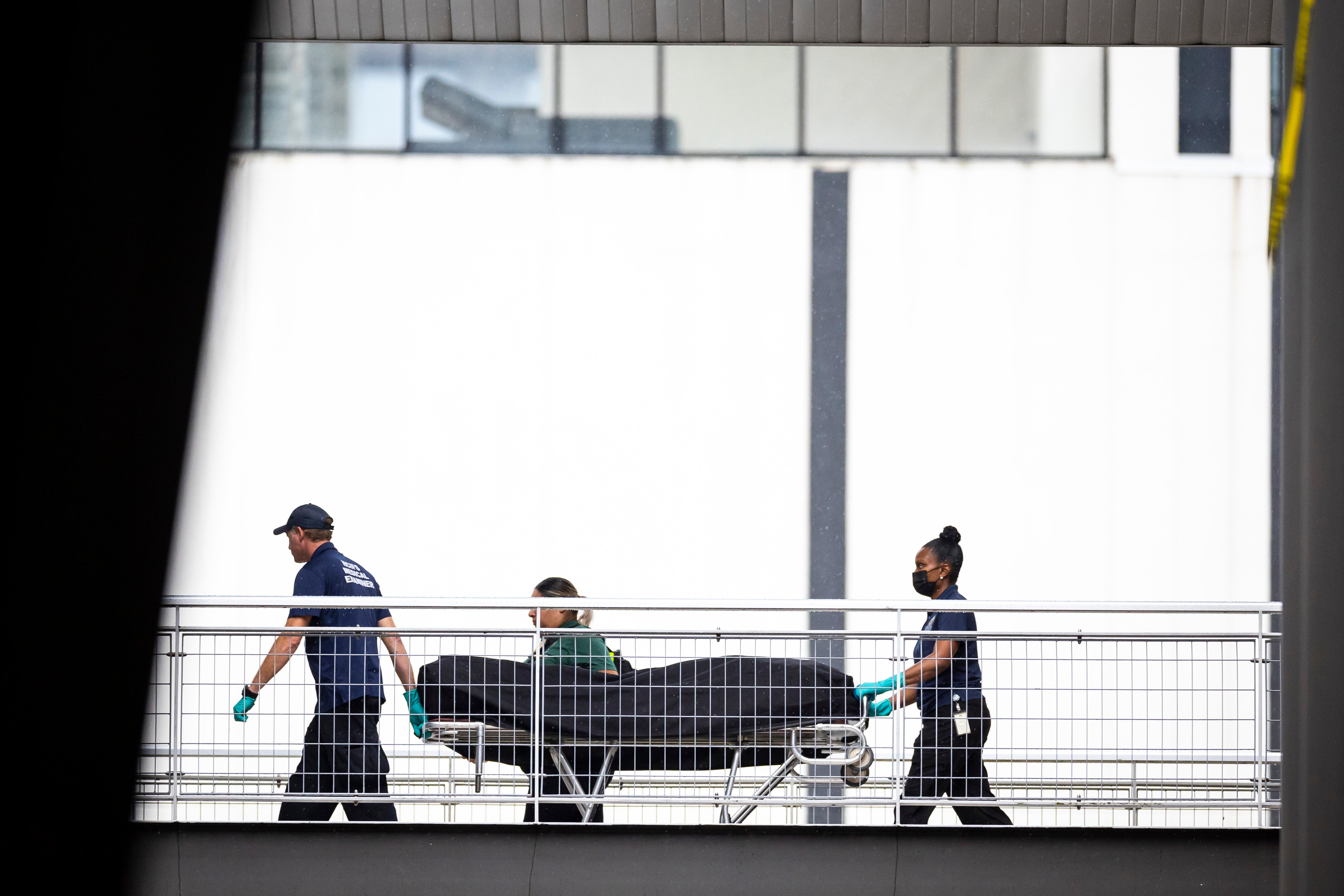 Officials wheel a body away at the scene of the shooting in Houston, Texas