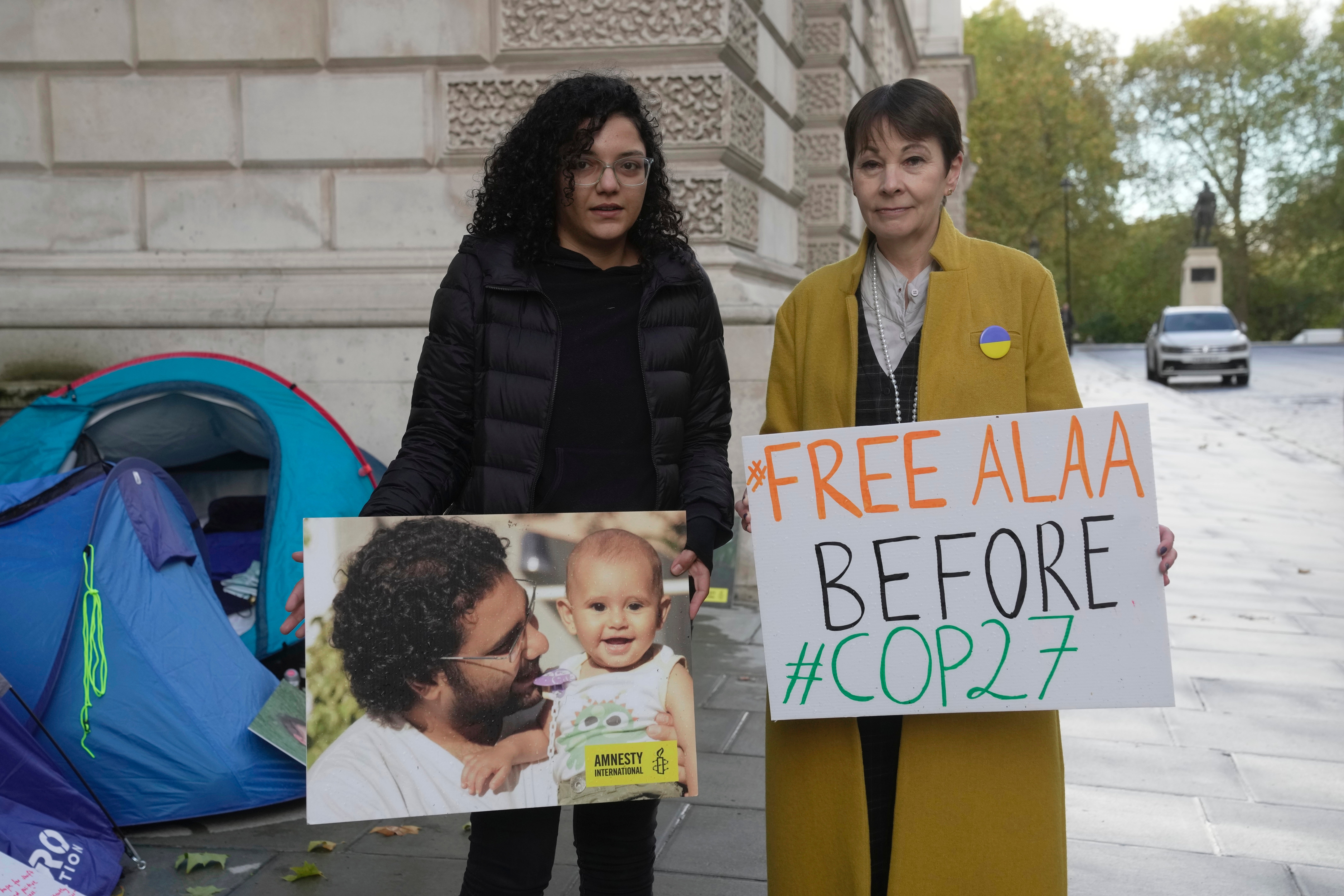 Sanaa Seif, sister of Egypt's leading pro-democracy activist Alaa Abdel-Fattah, left, with Caroline Lucas, Green Party MP outside the Foreign Office in London