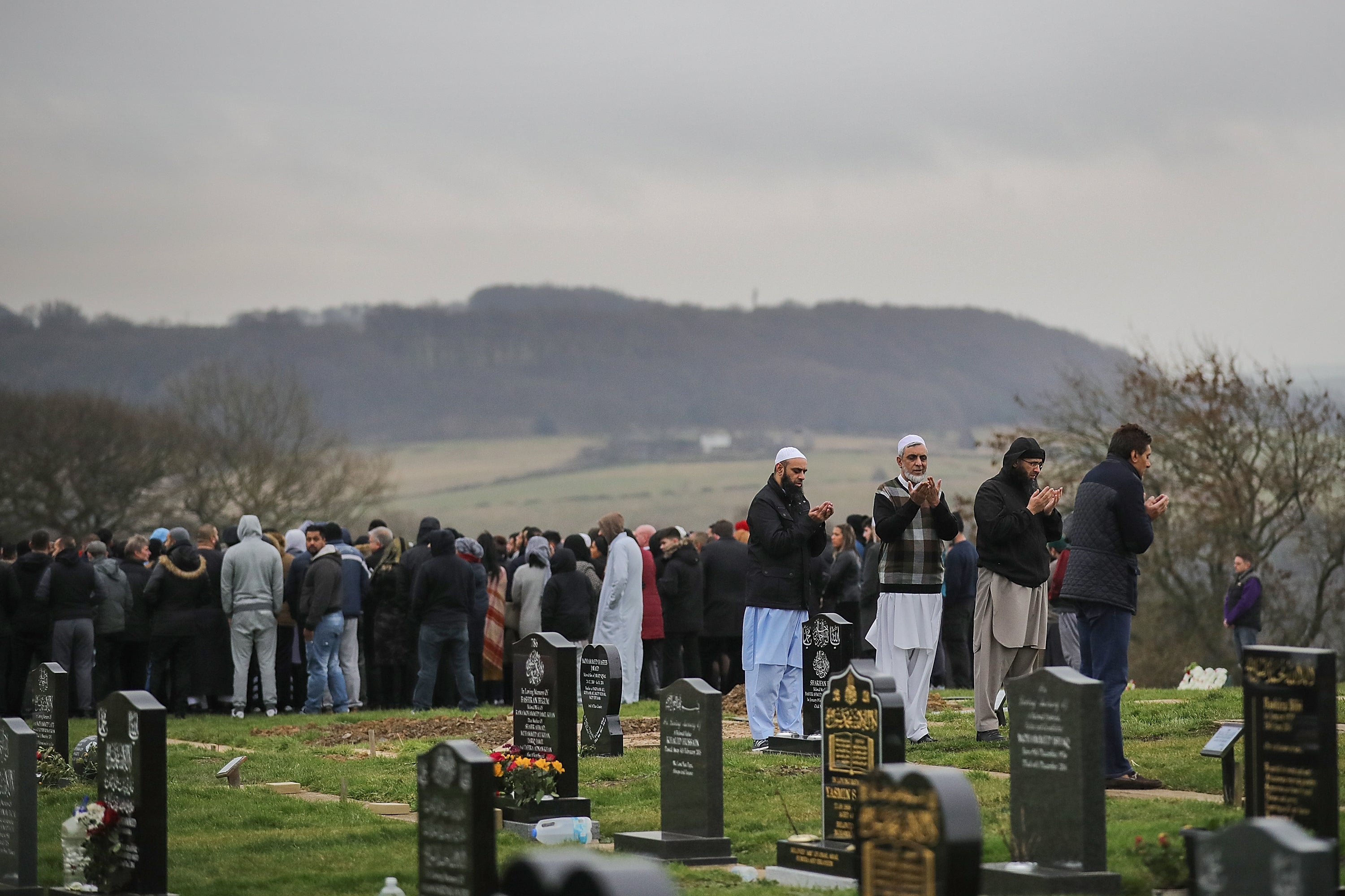 Mourners pray at Yaqub’s burial service in Hey Lane cemetery, Huddersfield