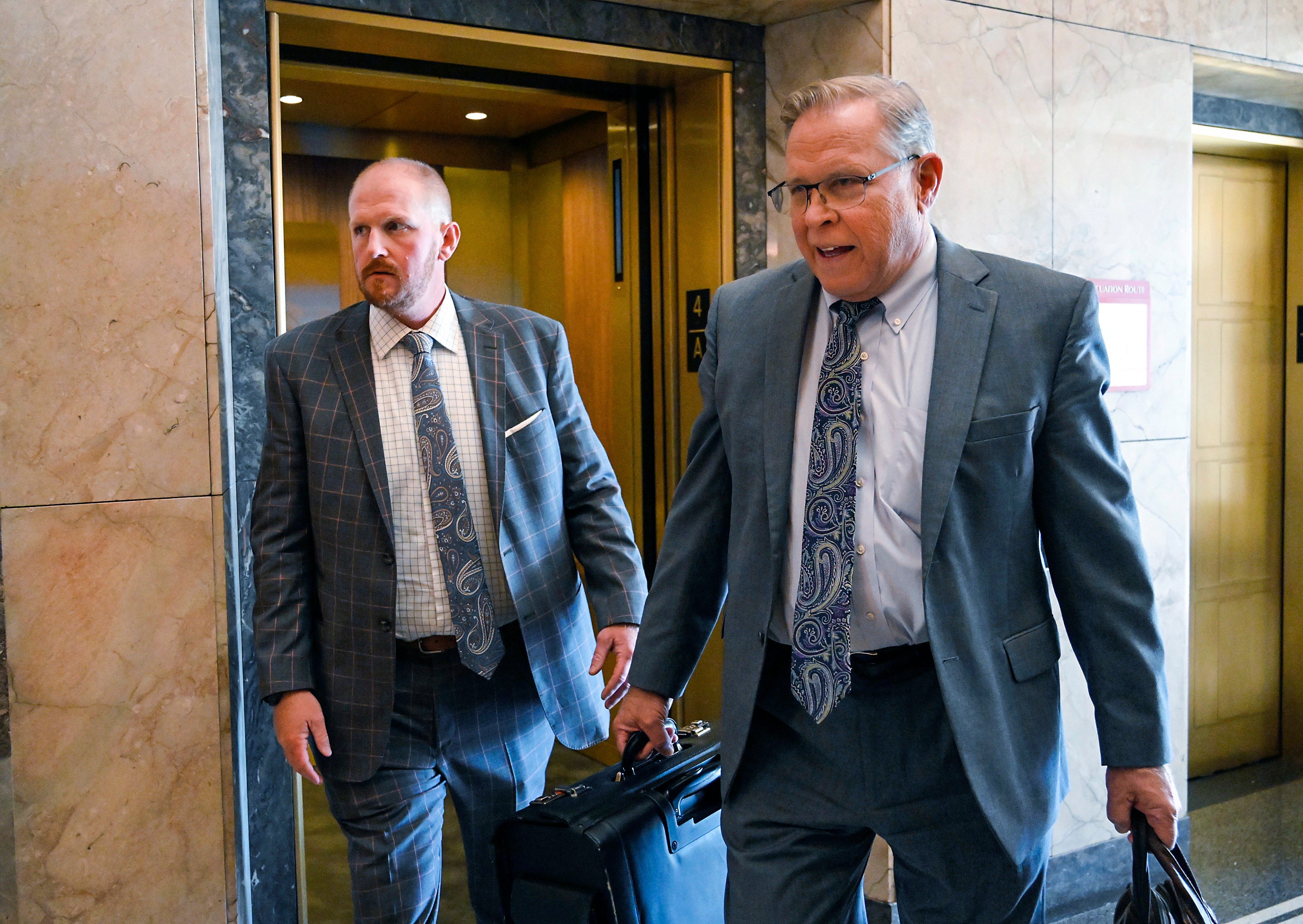 Britt Reid, left, walks to a courtroom with his attorney J.R. Hobbs, right, Tuesday, Nov. 1, 2022, at the Jackson County Courthouse, in Kansas City, Mo.