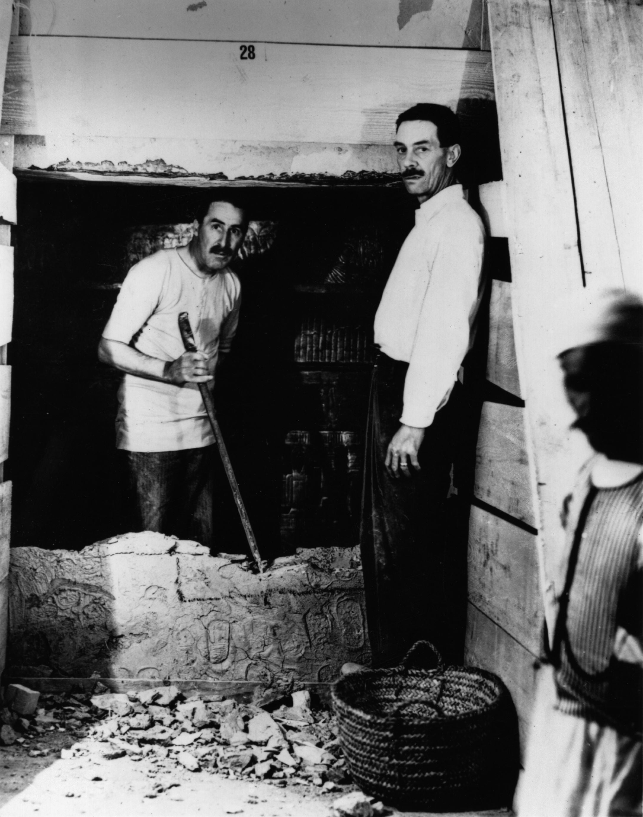 Carter and Arthur Mace opening the wall of the inner chamber of the tomb