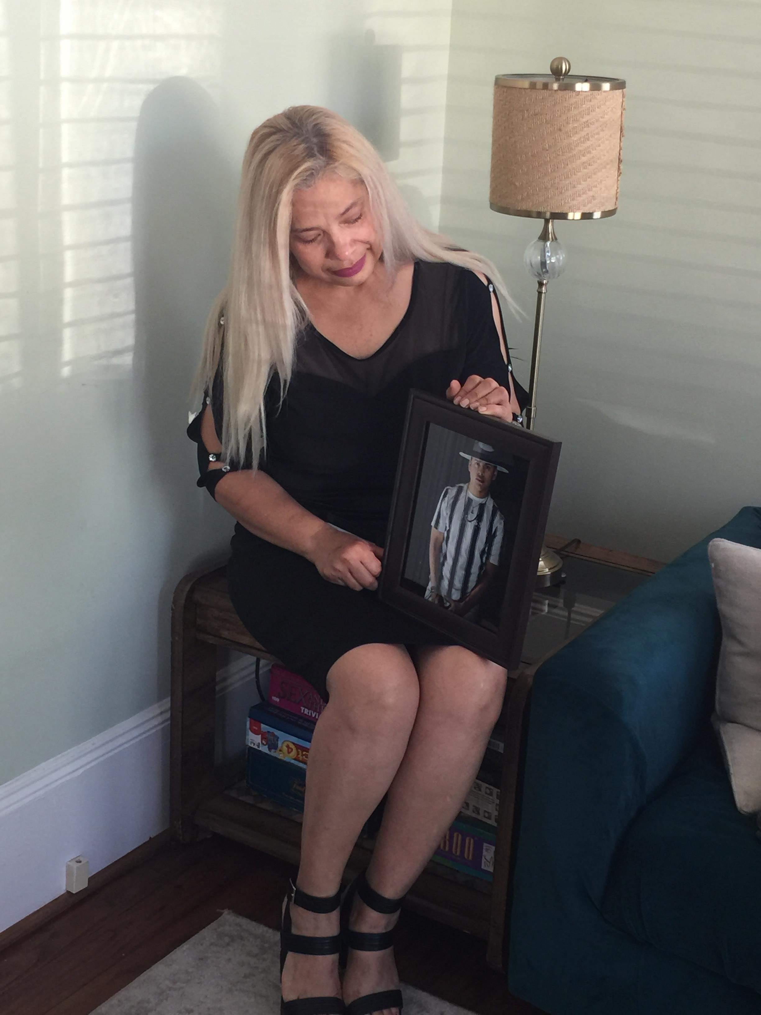 Maria De Los Angeles Pena holds a photo of her son Rudy, who was crushed in the Astroworld tragedy on 5 November 2021