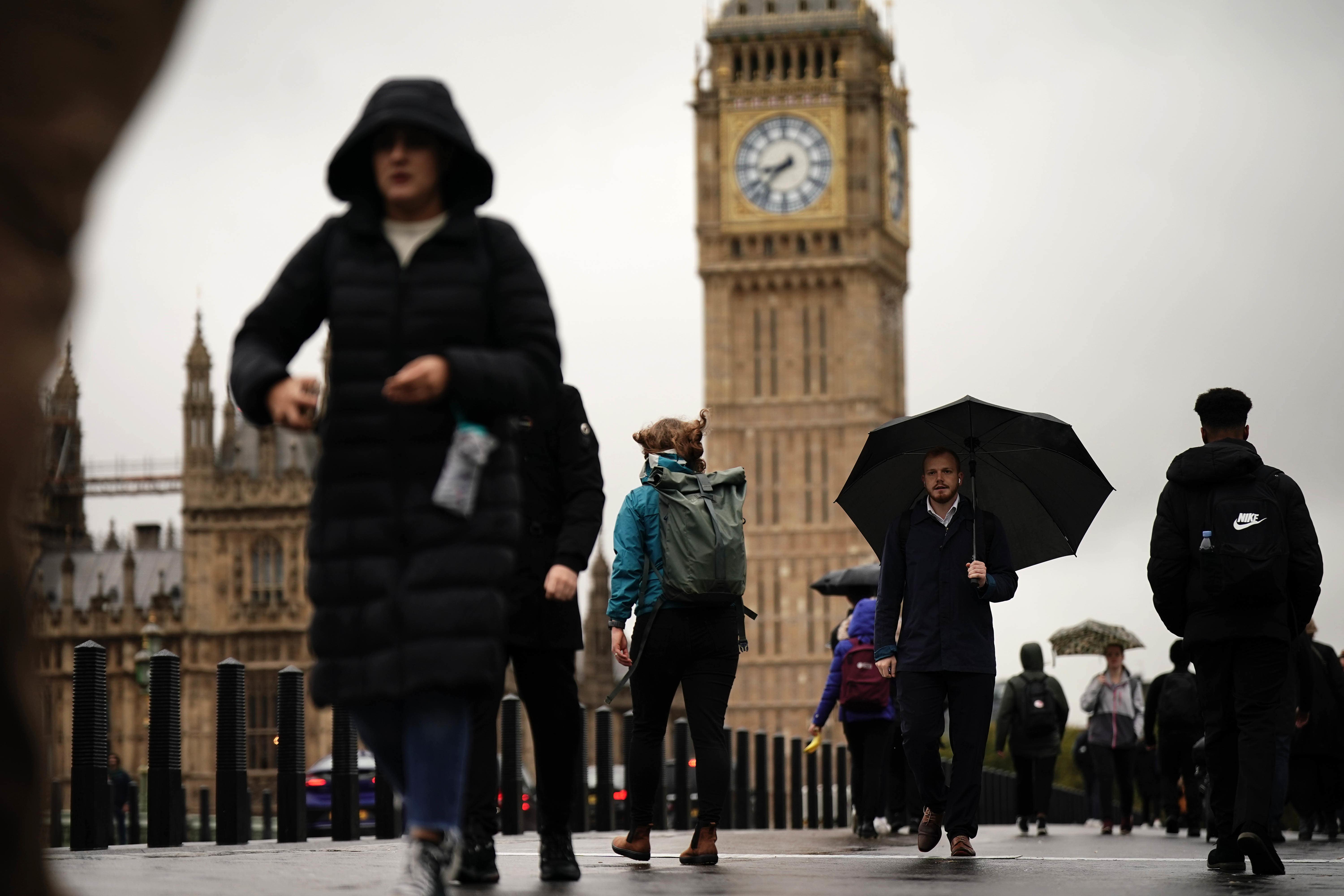 Commuters with umbrellas in Westminster in London