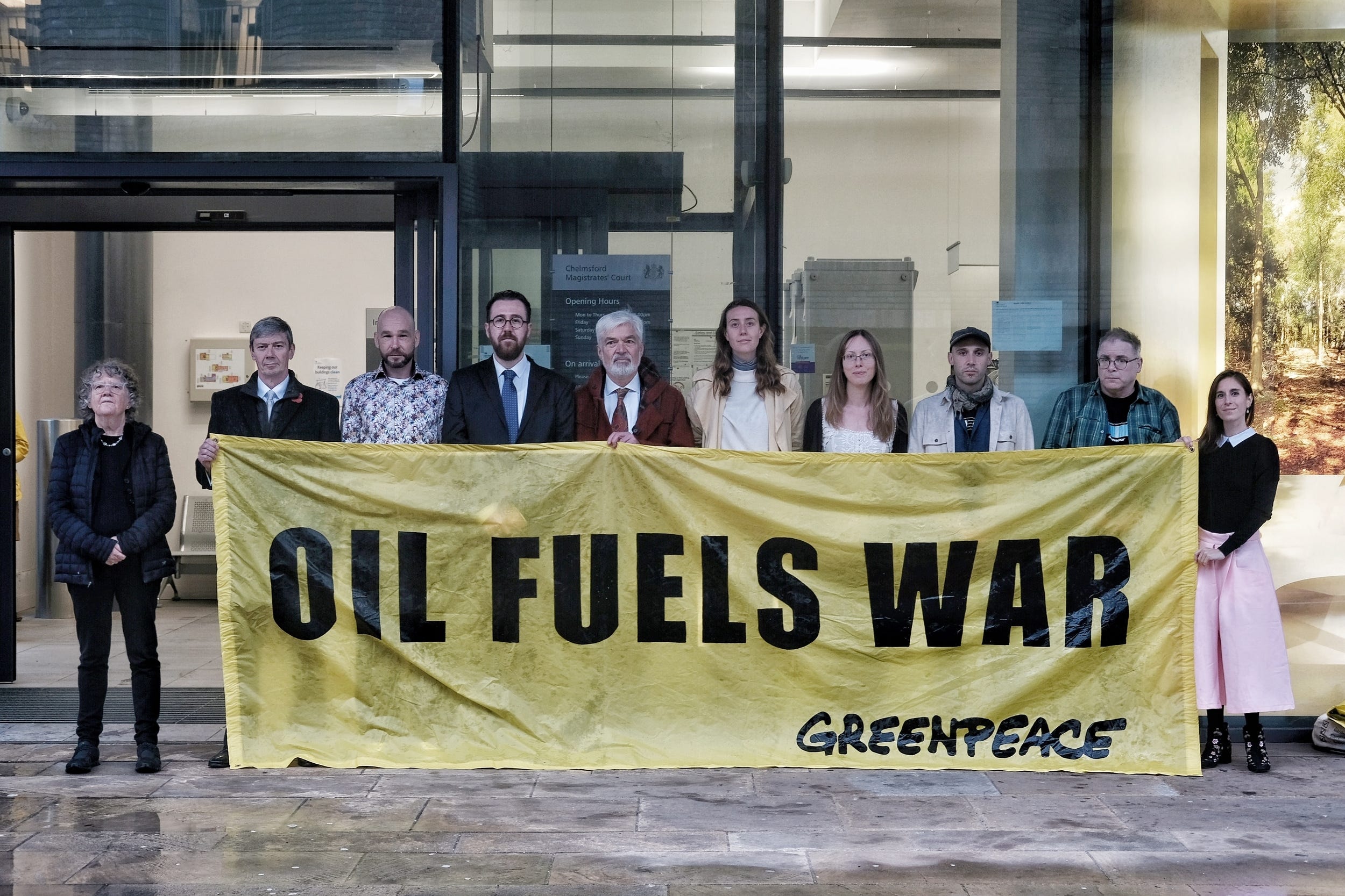 Greenpeace activists (left to right) Lyndall Stein, Mike Grant, Ben Hearne-Salter, Henry Rayner, David James, Rhiannon Wood, Kim Harrison, Benji Bailes, Ian Mills and Zoe Pontida outside Chelmsford Magistrates’ Court, Essex before their trial for blocking a jetty at Navigator oil terminal in Grays, Essex. (Greenpeace/ PA)