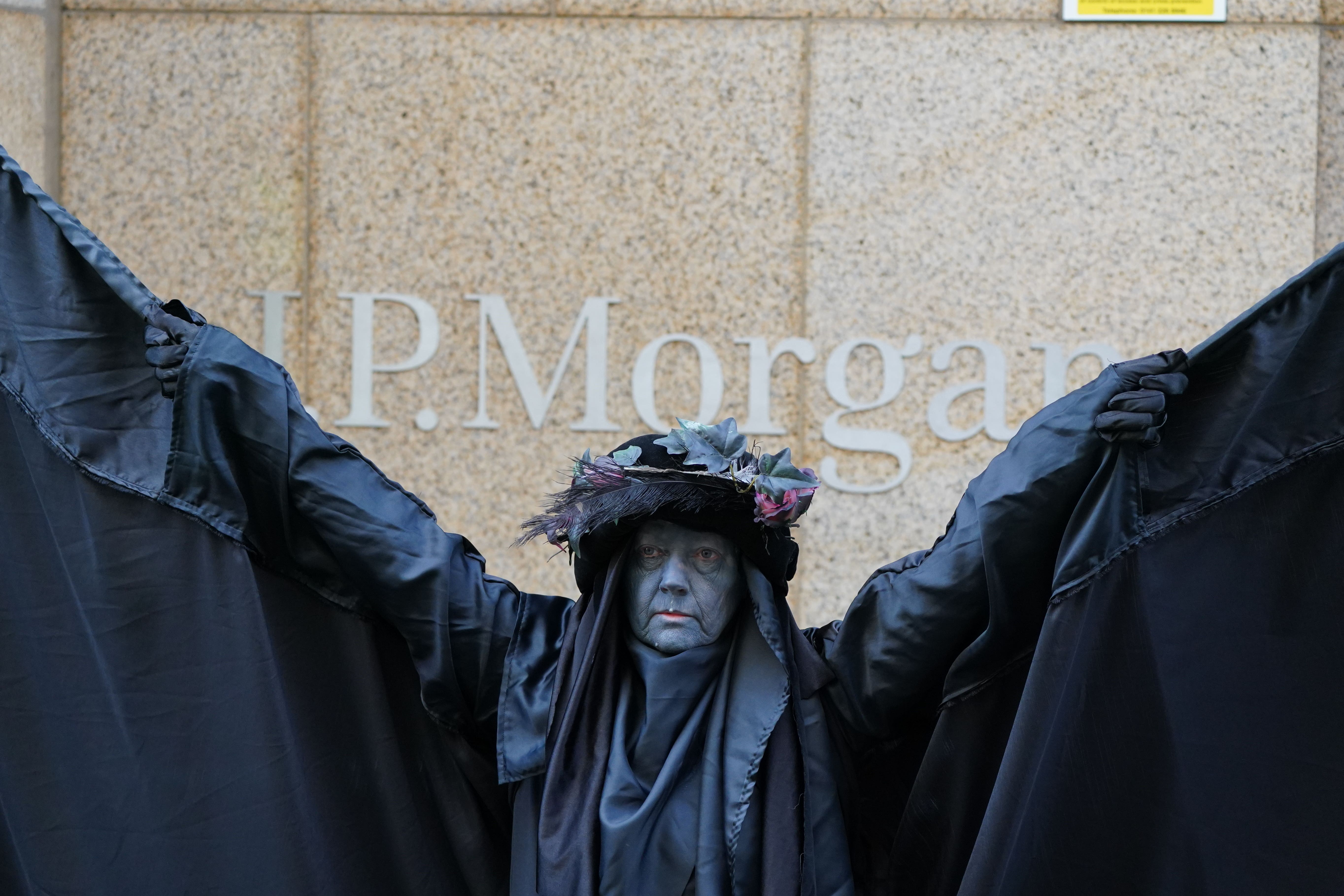 The Oil Slicks, an Extinction Rebellion protest troupe, joins the protest outside the offices of JP Morgan in Glasgow (Andrew Milligan/PA)