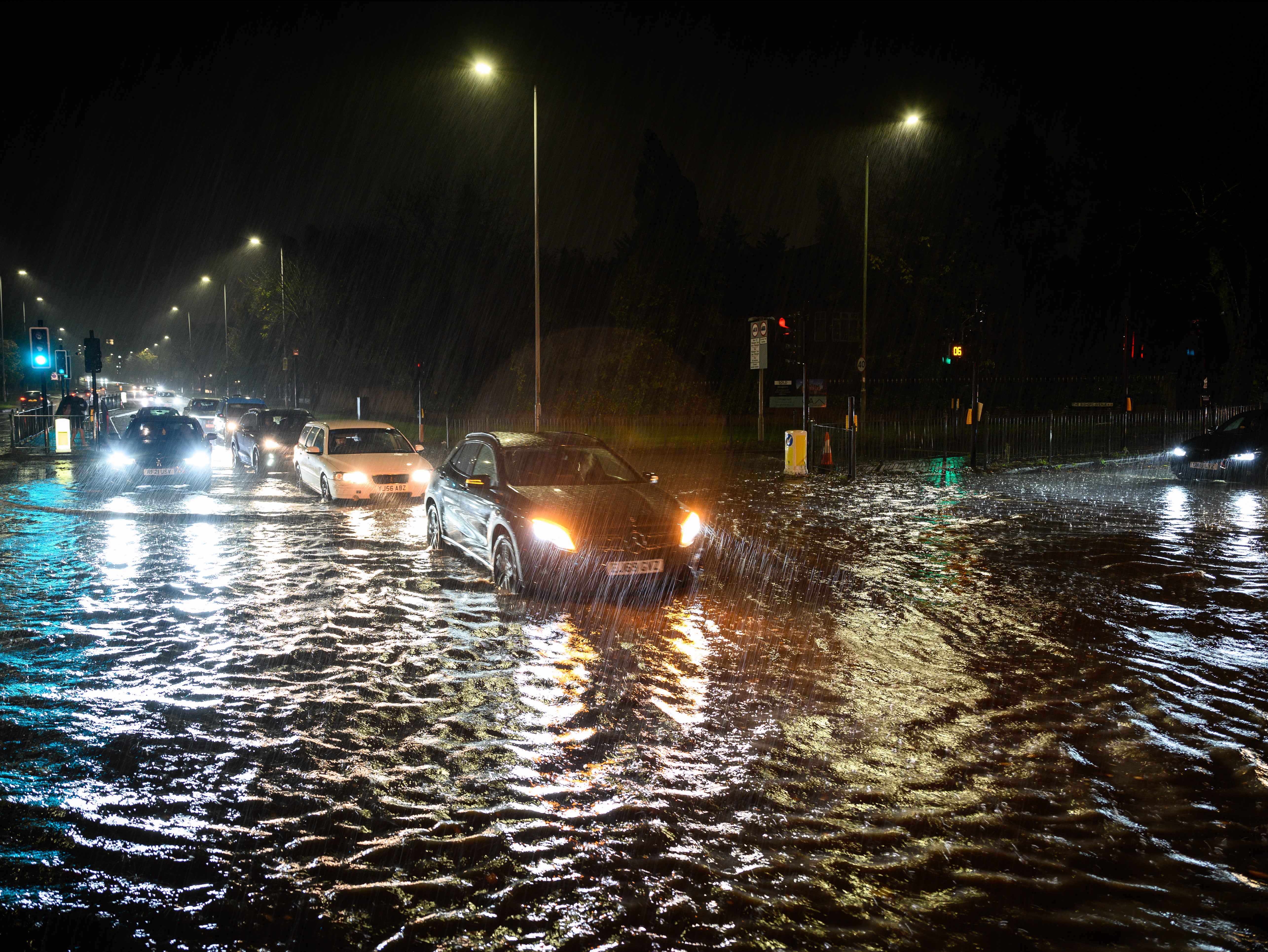 Vehicles negotiate a flooded section of the A1 road in London on Wednesday night