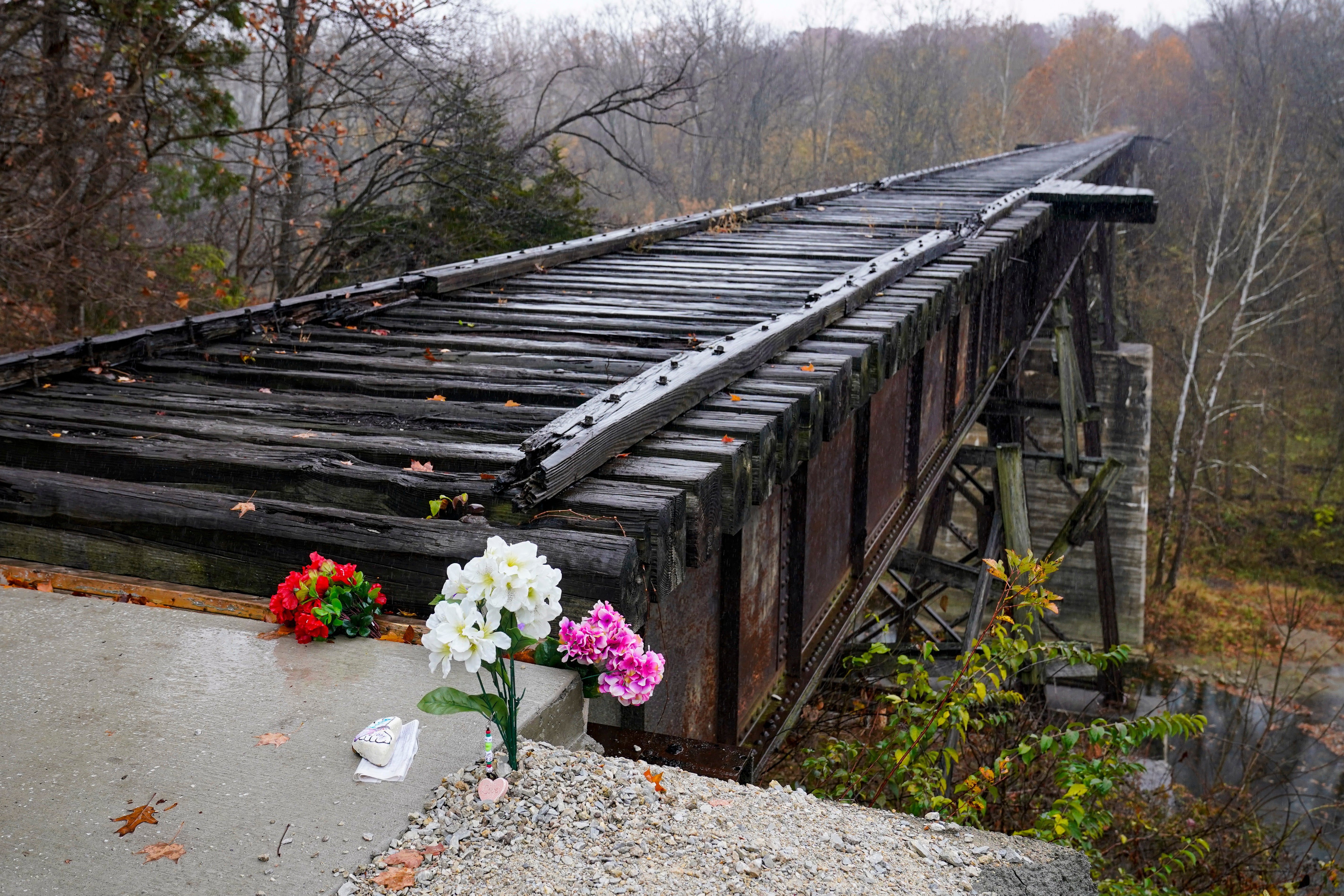 Flowers are placed at the Monon High Bridge where the girls were found dead