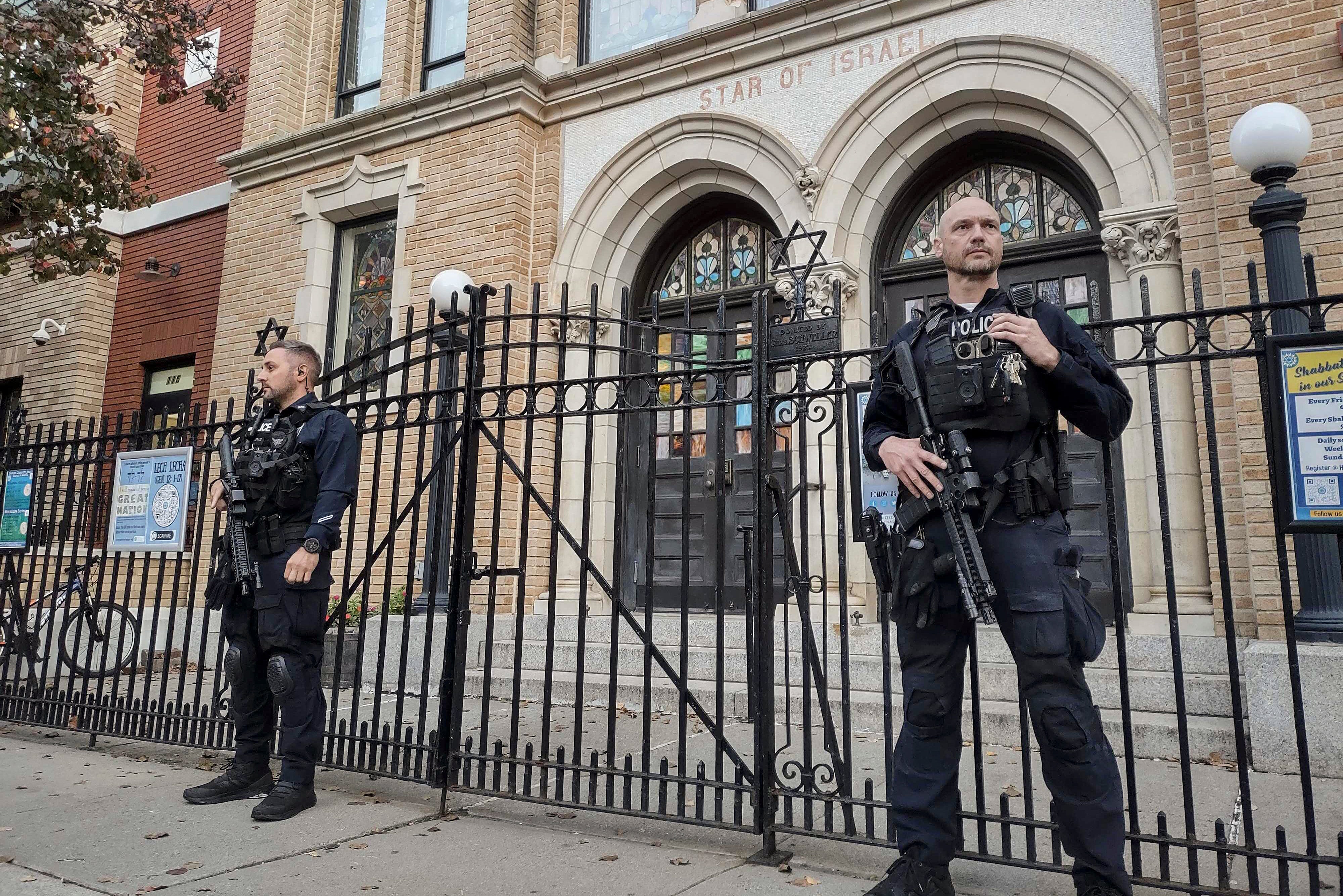 Hoboken Police officers stand watch outside the United Synagogue of Hoboken in New Jersey on Thursday