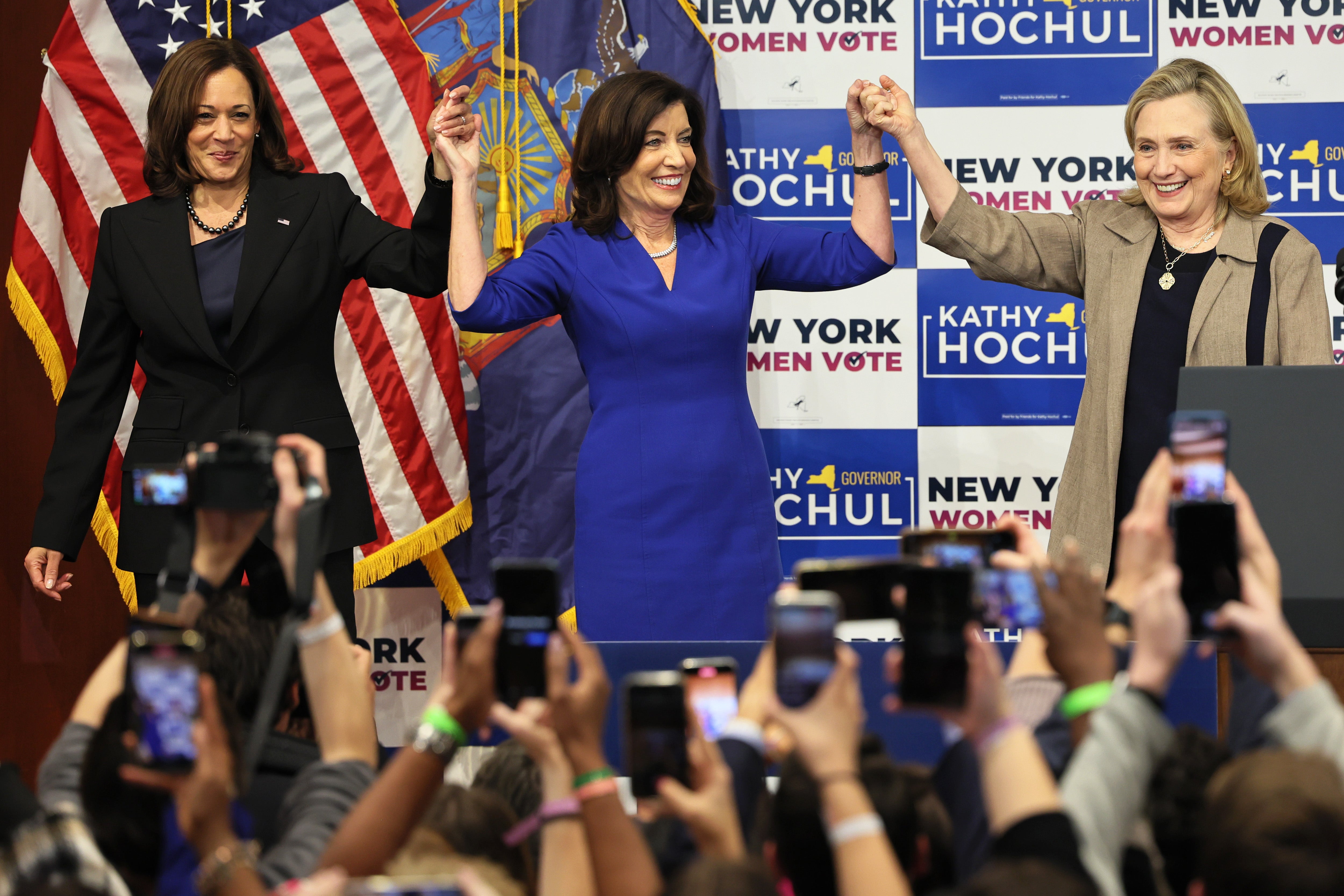 Harris, Gov. Kathy Hochul and former Secretary of State Hillary Rodham Clinton hold up their hands at the conclusion of a New York Women rally at Barnard College on November 03, 2022, in New York City