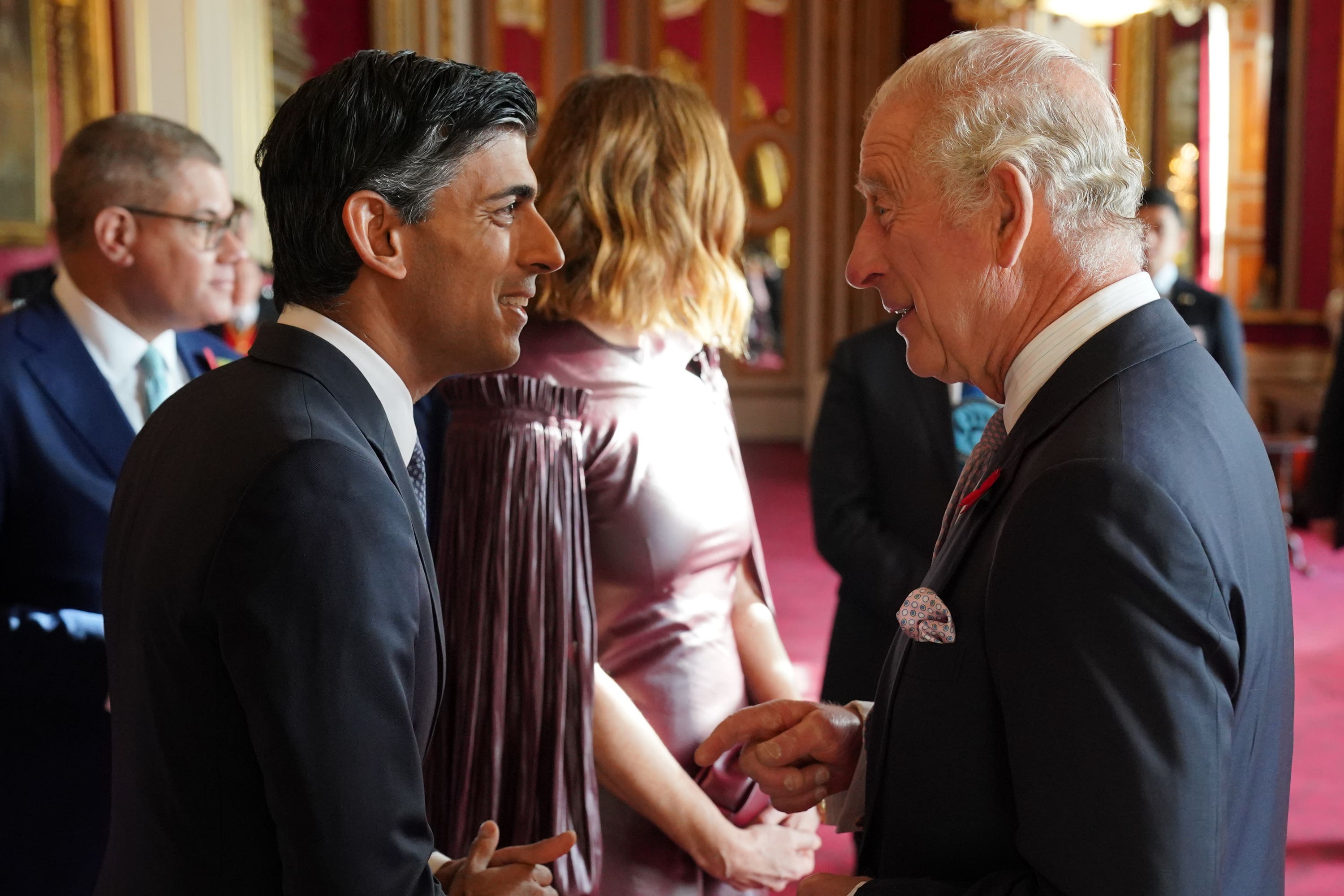 Charles speaks with the Prime Minister during the reception at Buckingham Palace