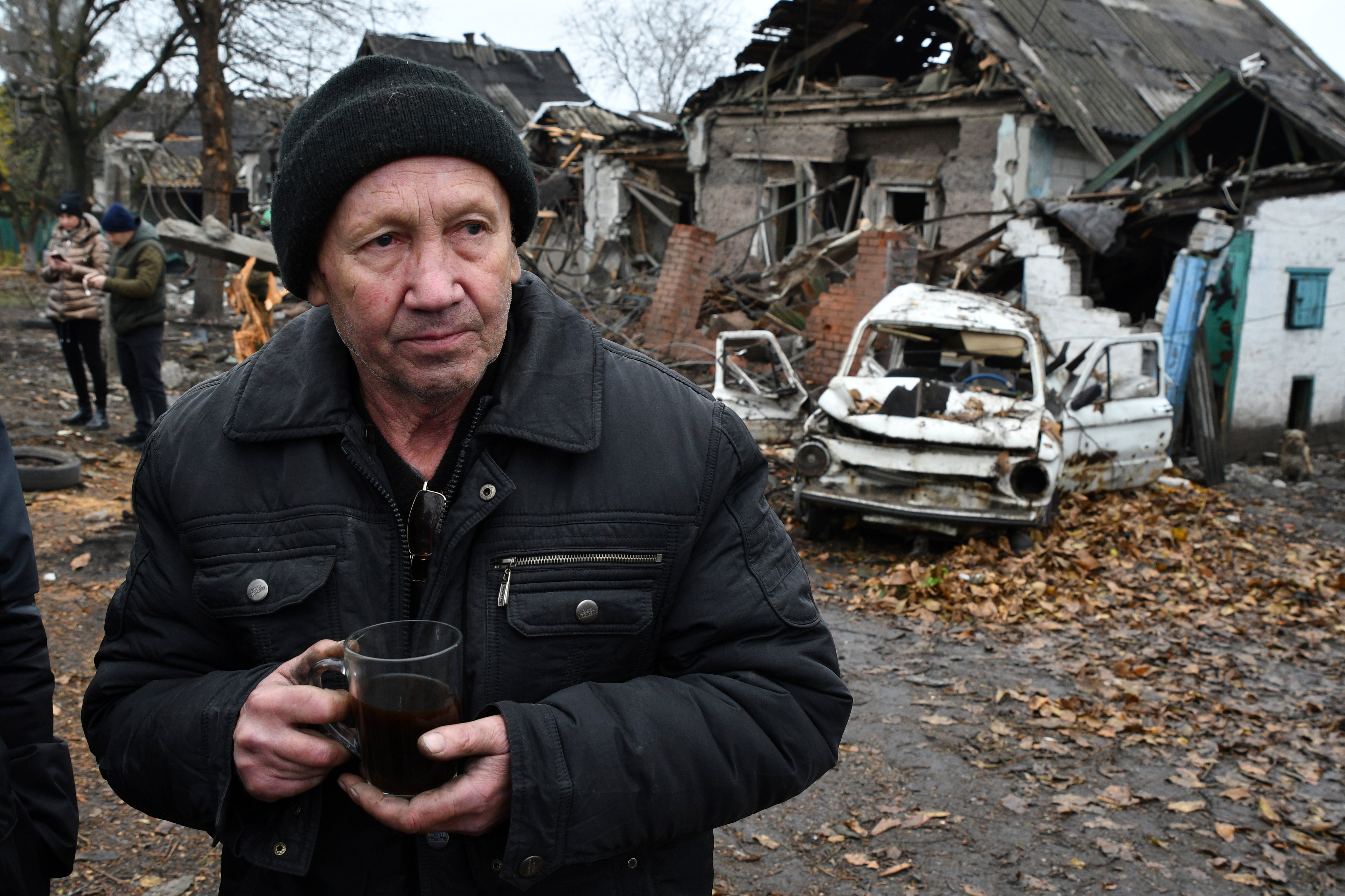 Ivan Kulta, 68, drinks tea next to his destroyed apartment building after Russian shelling in Pokrovsk, Donetsk region