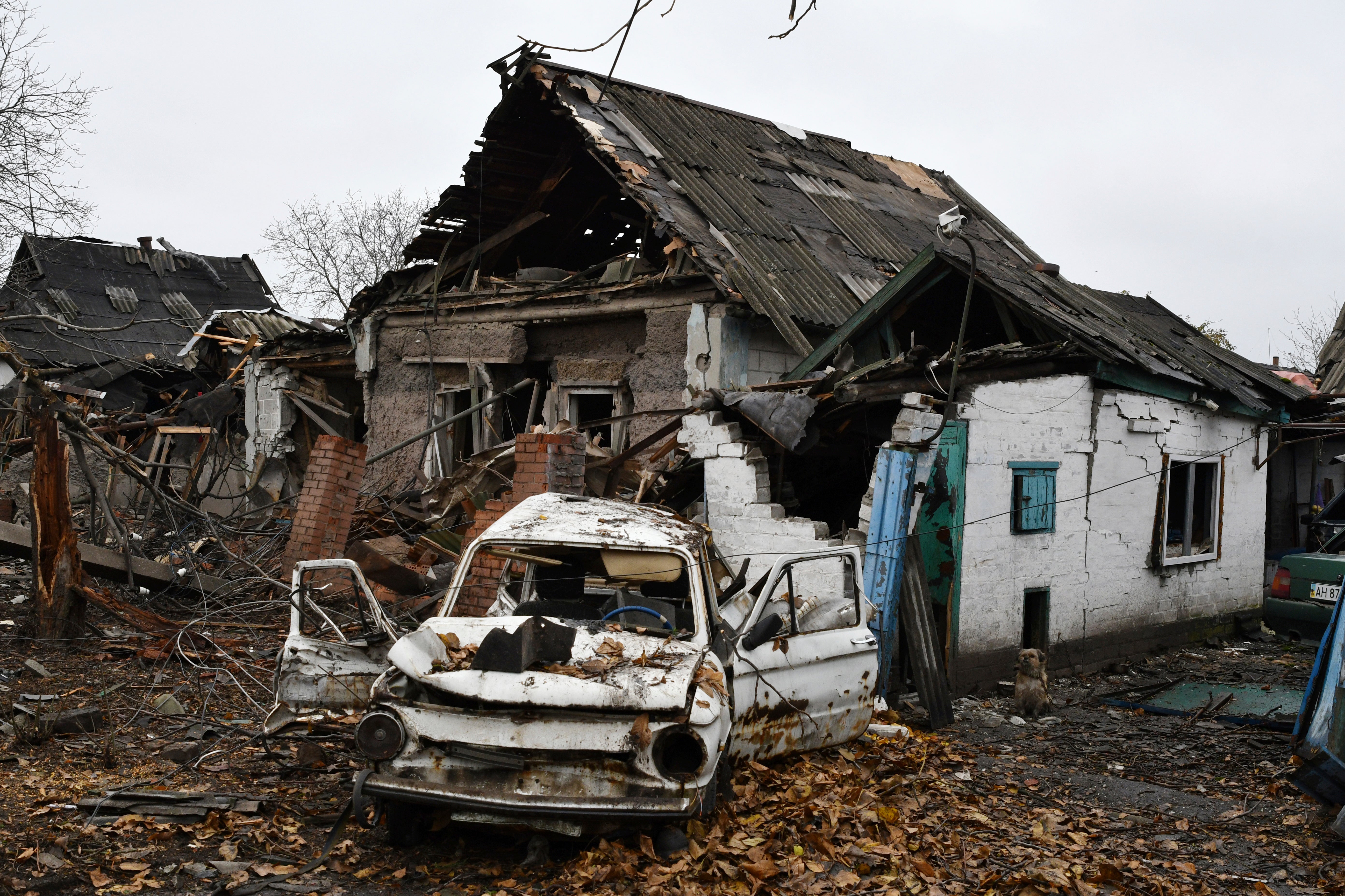 A damaged Soviet-era Ukrainian car "Zaporozhets" is seen damaged next to a destroyed apartment building after Russian shelling in Pokrovsk, Donetsk region