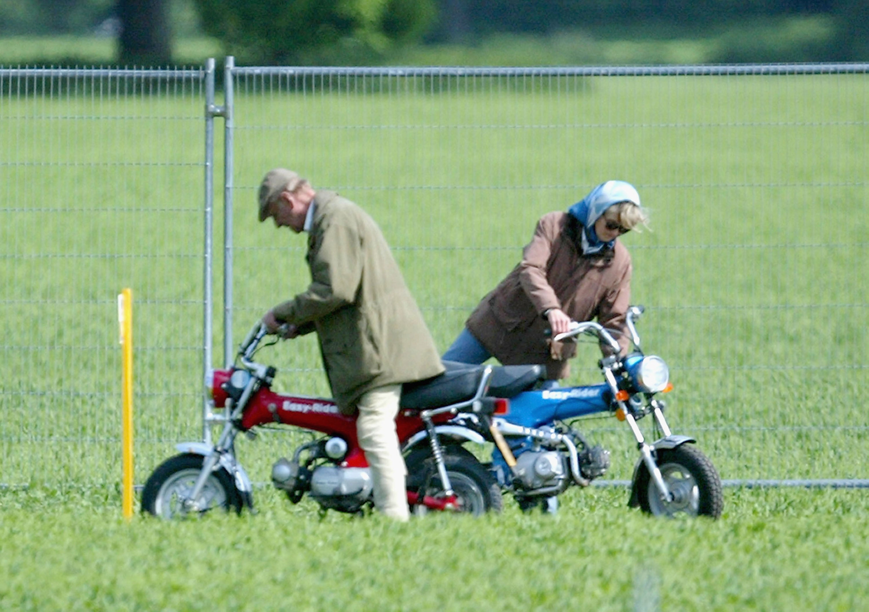 HRH Prince Philip, The Duke of Edinburgh and Lady Penny Romsey mount their mini motorbikes during the Royal Windsor Horse Show at Home Park, Windsor Castle on May 13, 2005