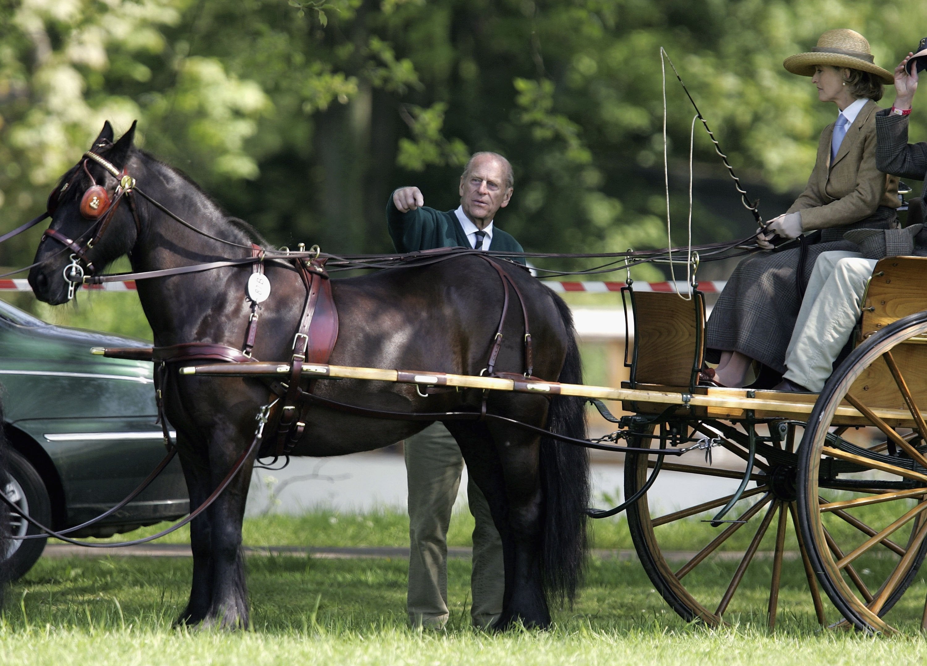 Prince Philip, Duke of Edinburgh points over Lady Penny Brabourne's horse before it competes in the Land Rover International Driving Grand Prix on May 11, 2006