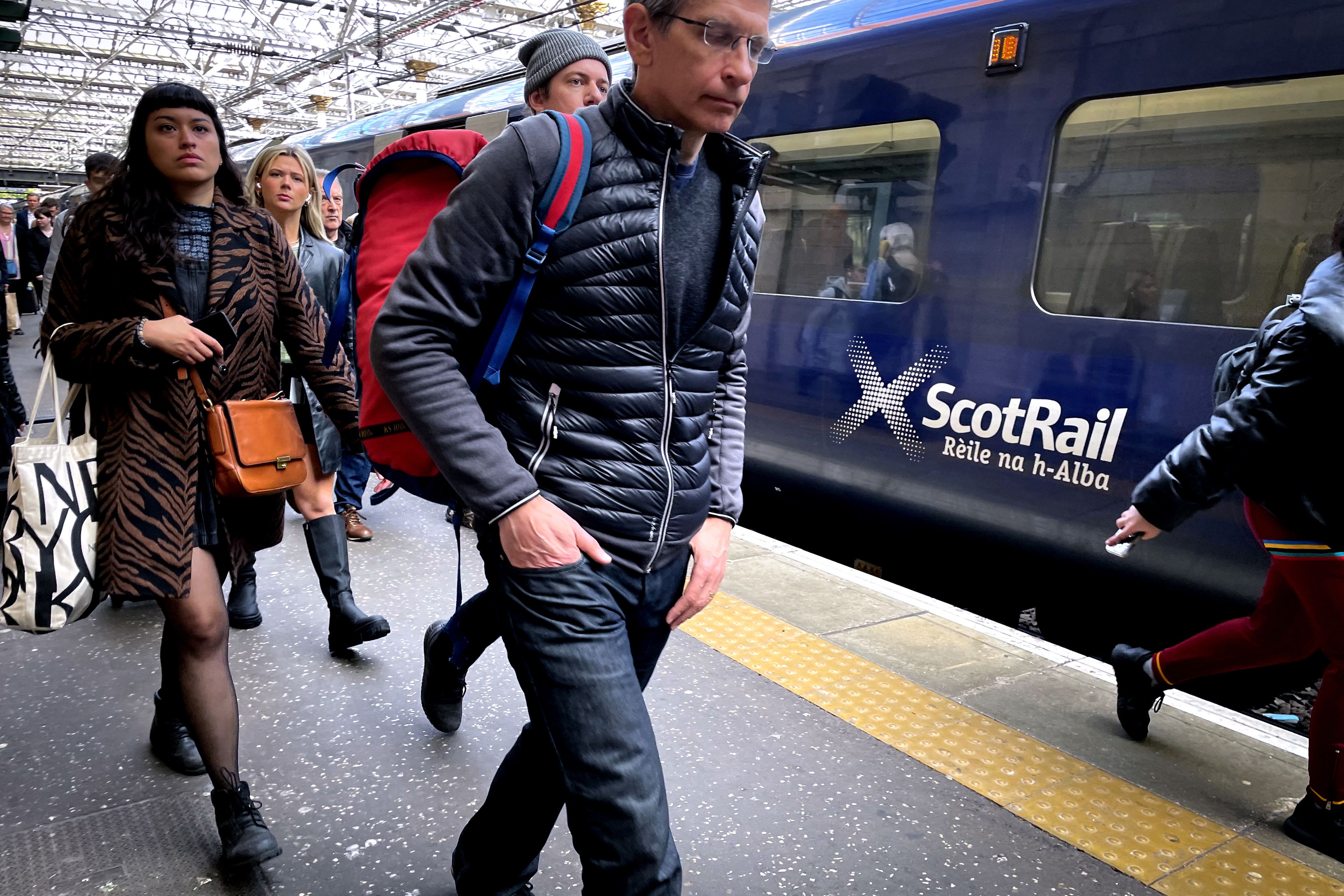 Commuters and travellers at Edinburgh’s Waverley Station (Jane Barlow/PA)
