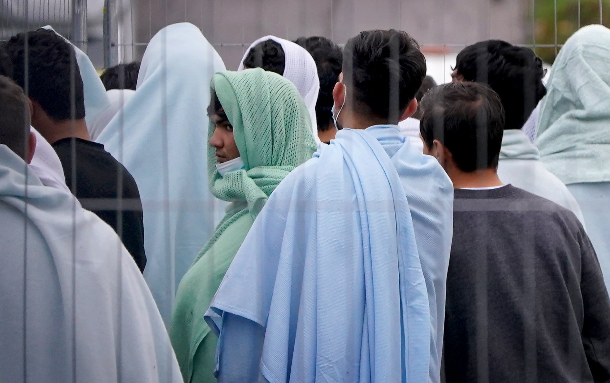 A view of people thought to be migrants inside the Manston immigration short-term holding facility