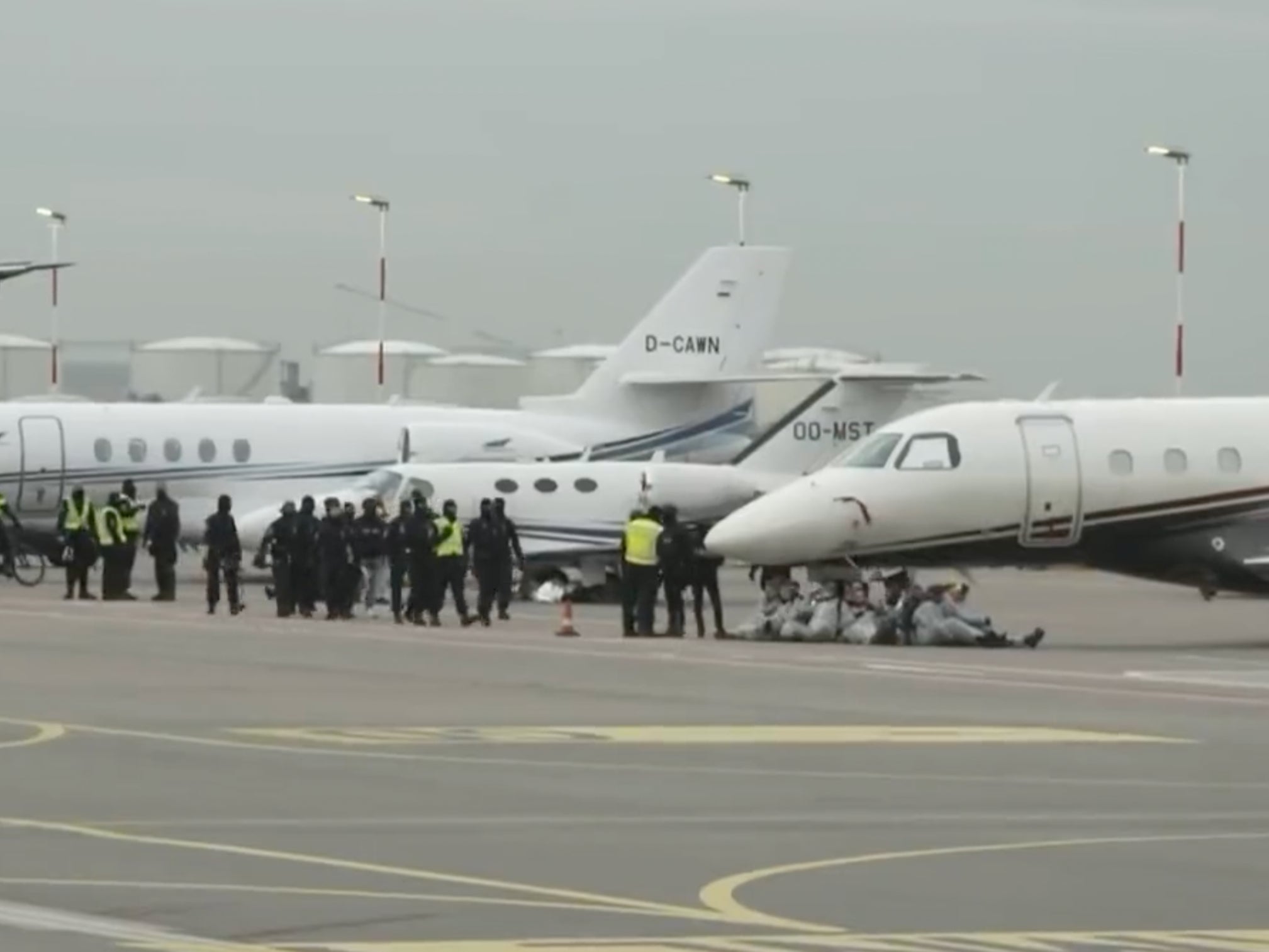 Environmental activists block private jets at Amsterdam’s Schiphol Airport