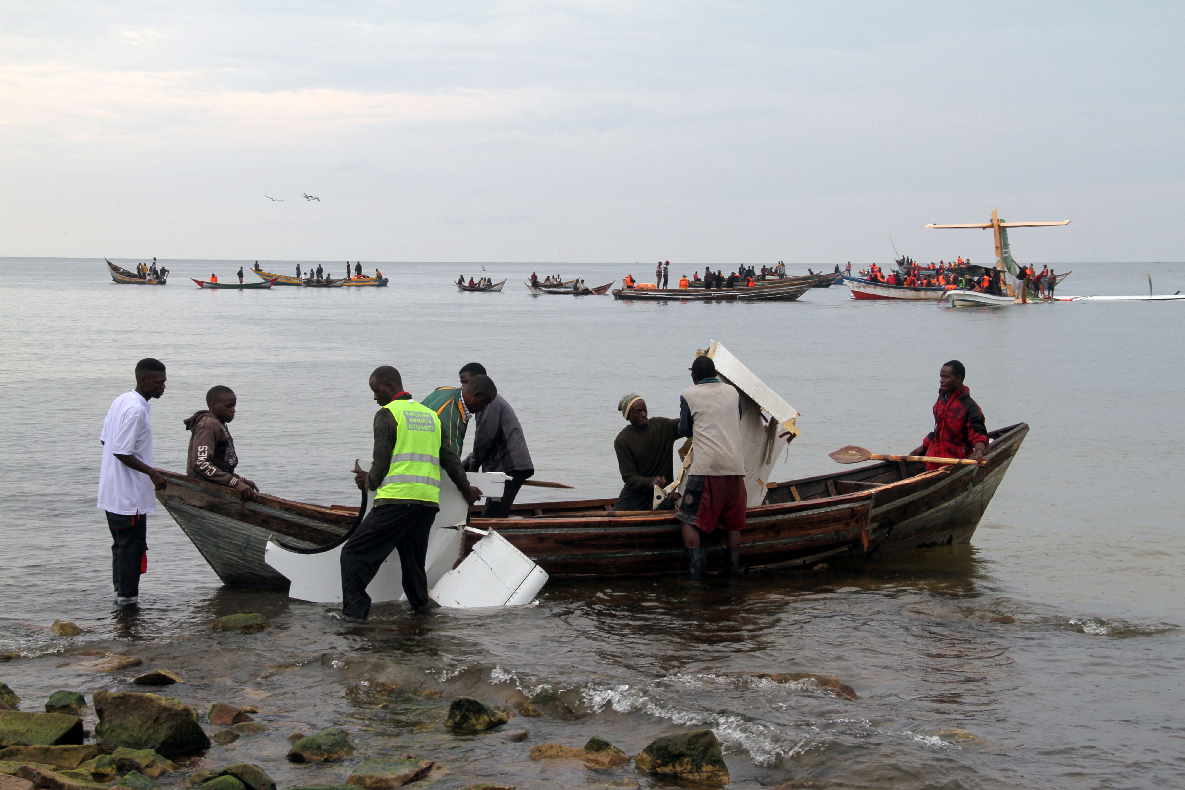 Rescuers carry debris as they search for survivors