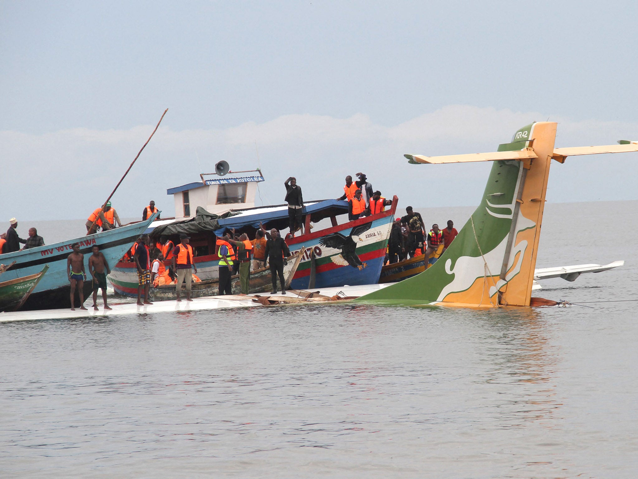 Passengers are taken to safety from the jet in the lake