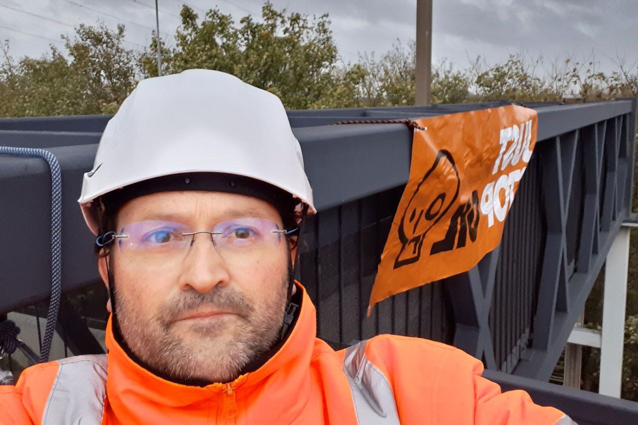 A Just Stop Oil protestor who climbed a gantry on the M25 between junctions six and seven in Surrey (Just Stop Oil/PA)