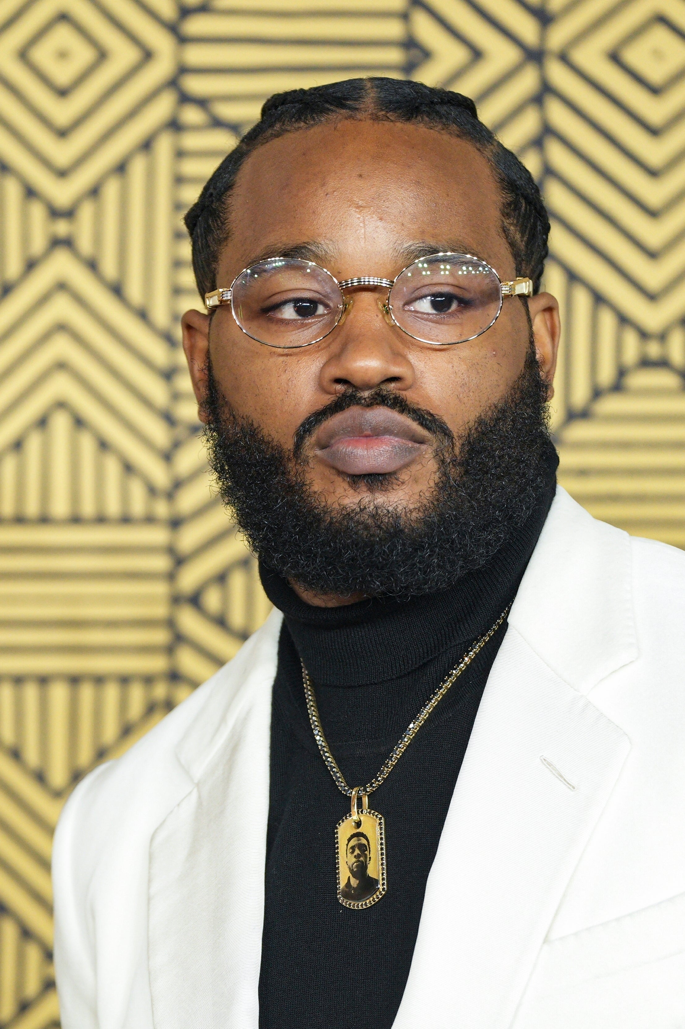 Coogler wearing a necklace with the image Boseman on it for the premiere of ‘Black Panther: Wakanda Forever’